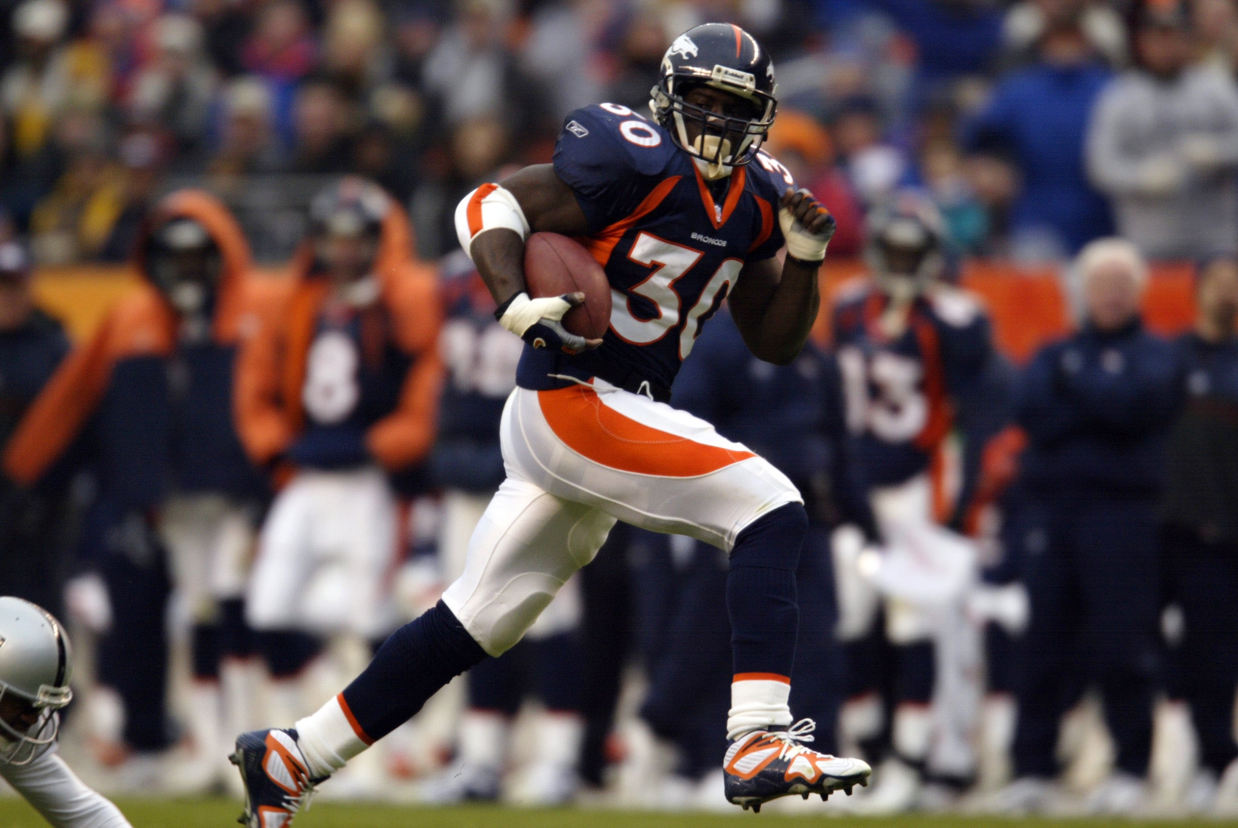 Terrell Davis, pictured playing for the Denver Broncos in 2001, said the United Airlines incident has left a lasting mark on his family