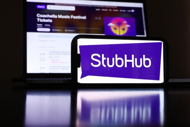 <p>The StubHub logo and webpage on a cell phone and computer monitor on April 17, 2024 in Los Angeles, California</p>