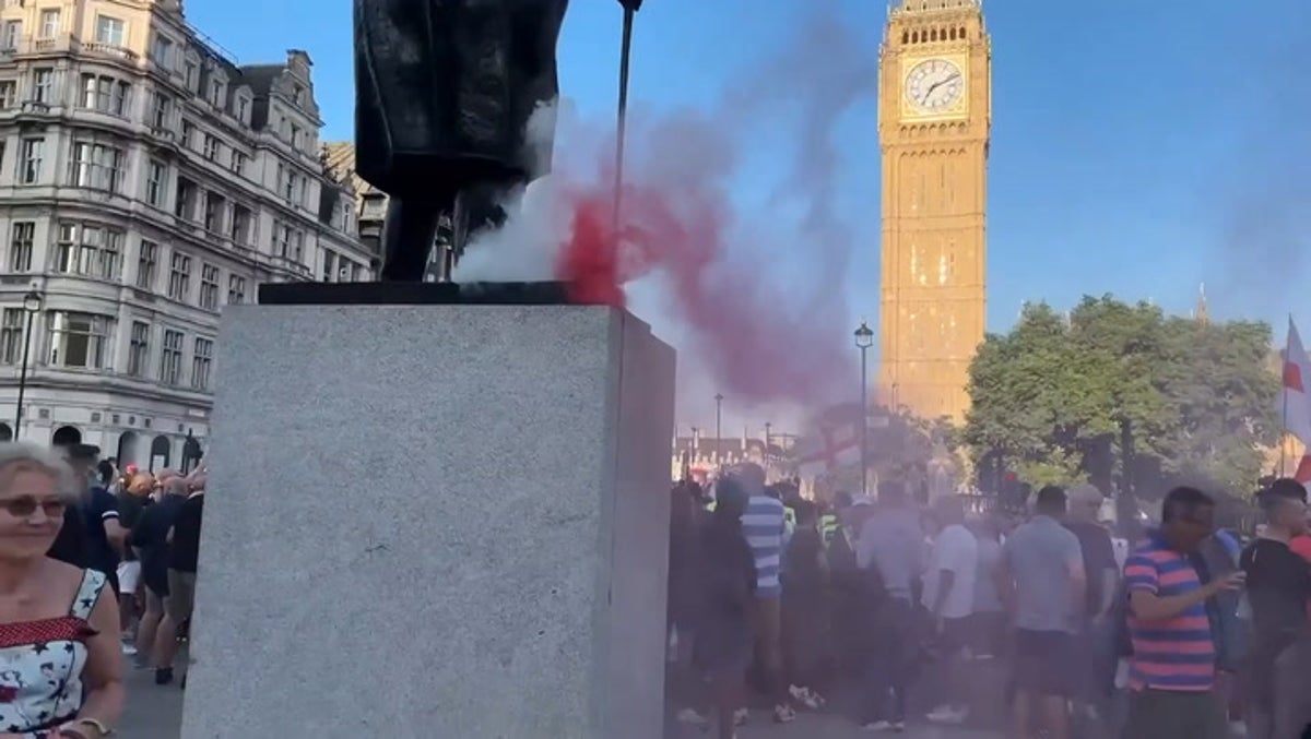 Flares set off on Churchill statue as protesters clash with riot police near Downing Street