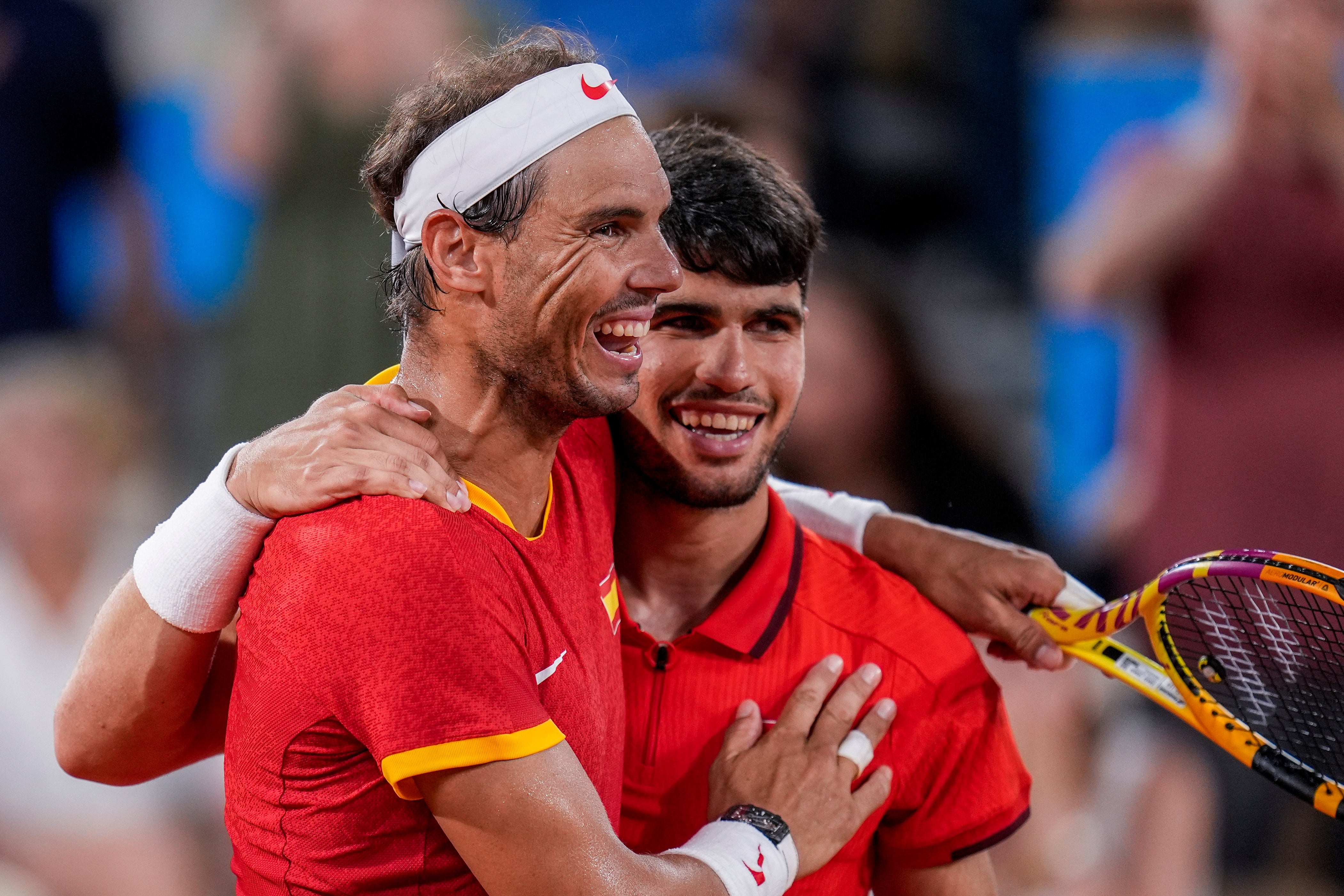 Rafael Nadal, left, and Carlos Alcaraz embrace (Manu Fernandez/AP)