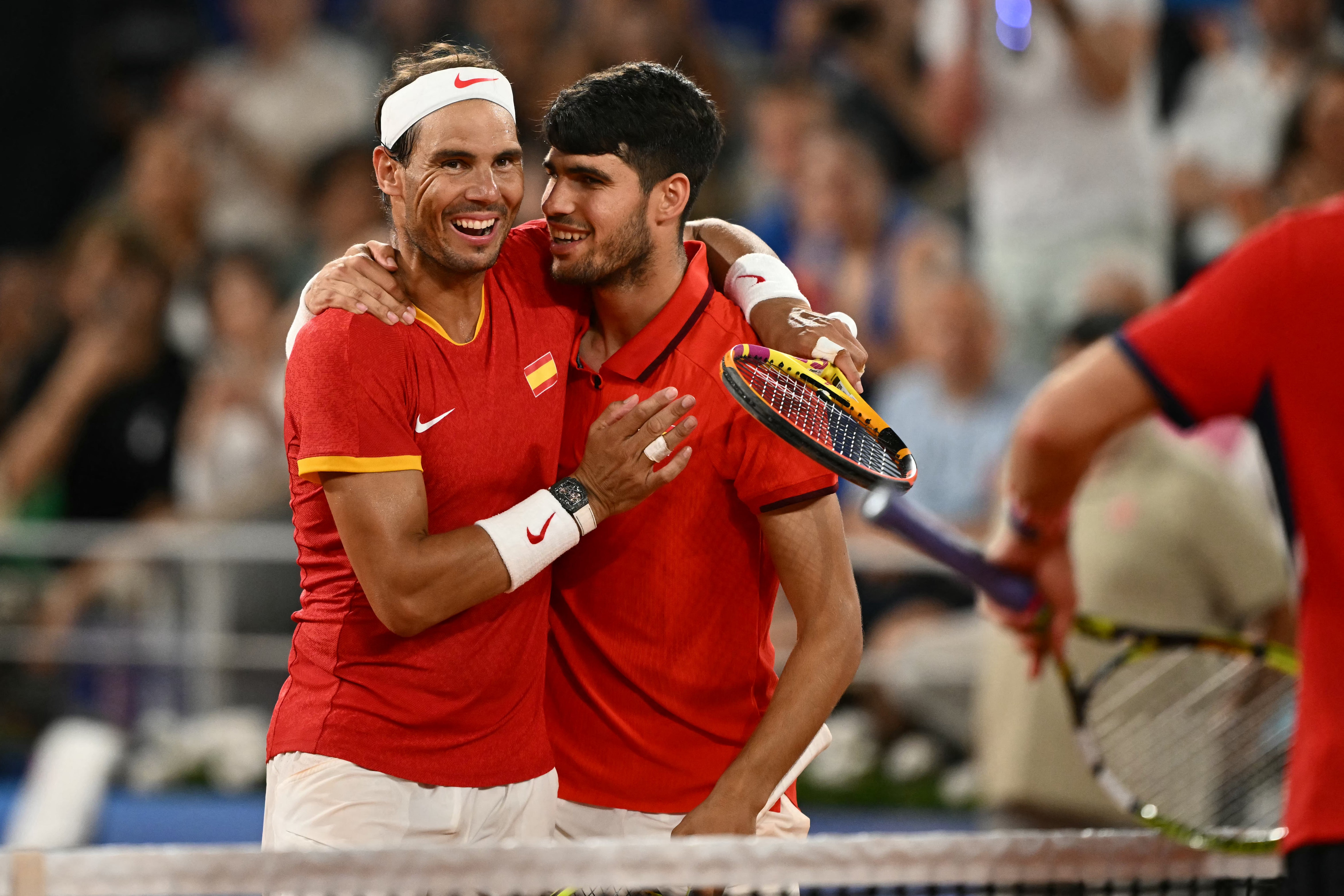 Spain's Rafael Nadal (L) embraces Spain's Carlos Alcaraz