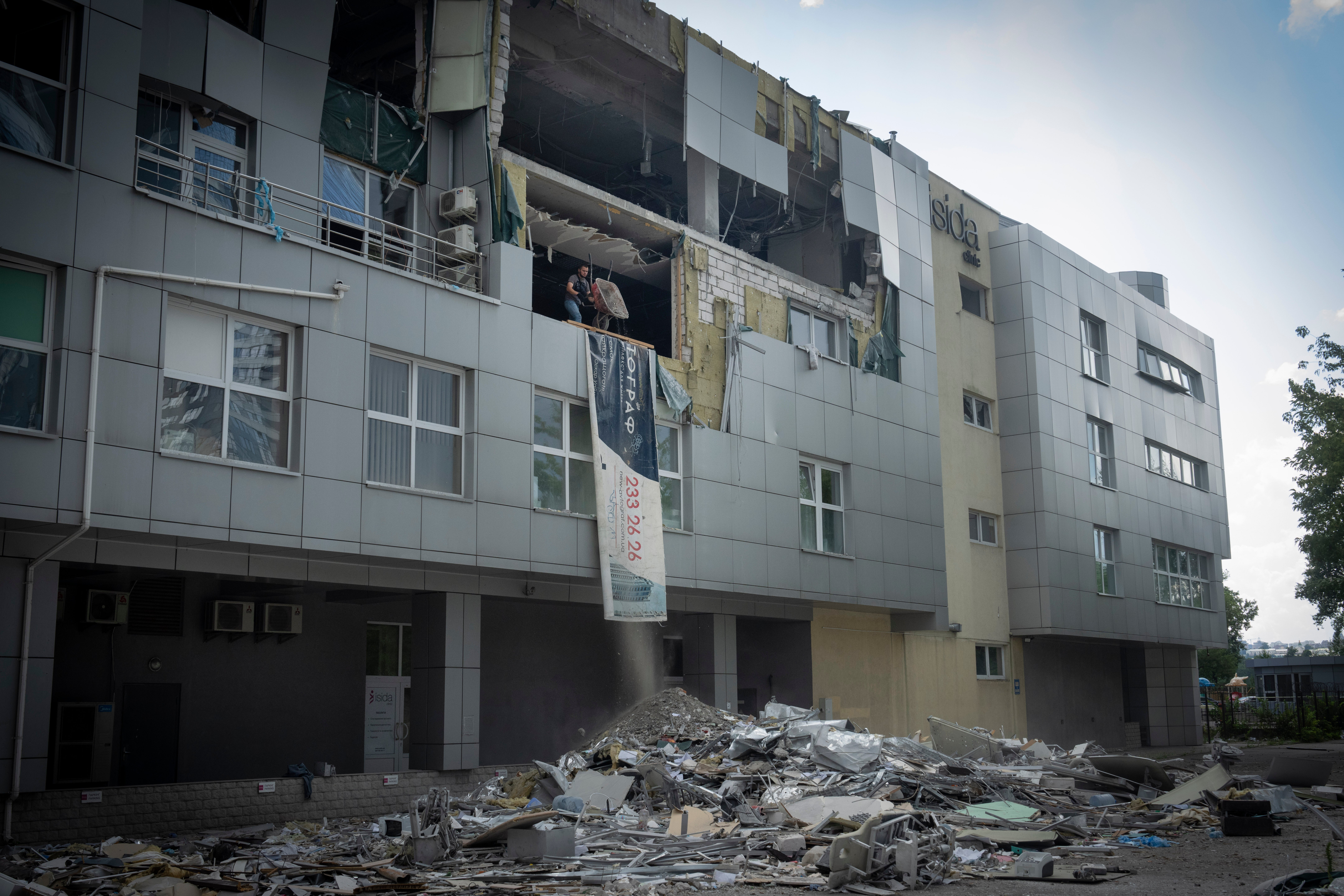 A worker cleans up the debris two weeks after a missile hit a private medical clinic, killing nine in Kyiv, Ukraine