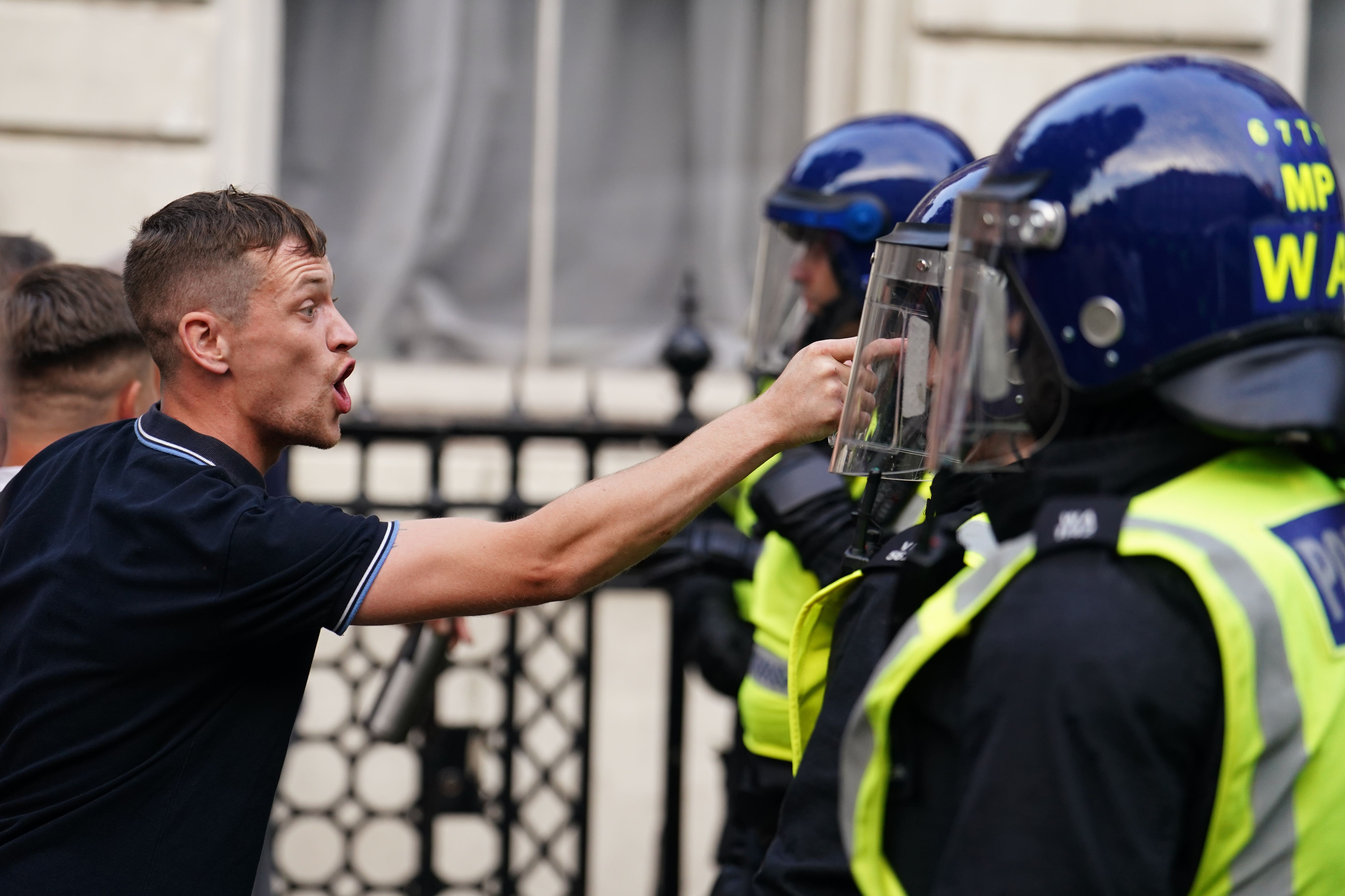 A demonstration outside Downing Street descended into violence as protesters threw bottles at police officers on Wednesday