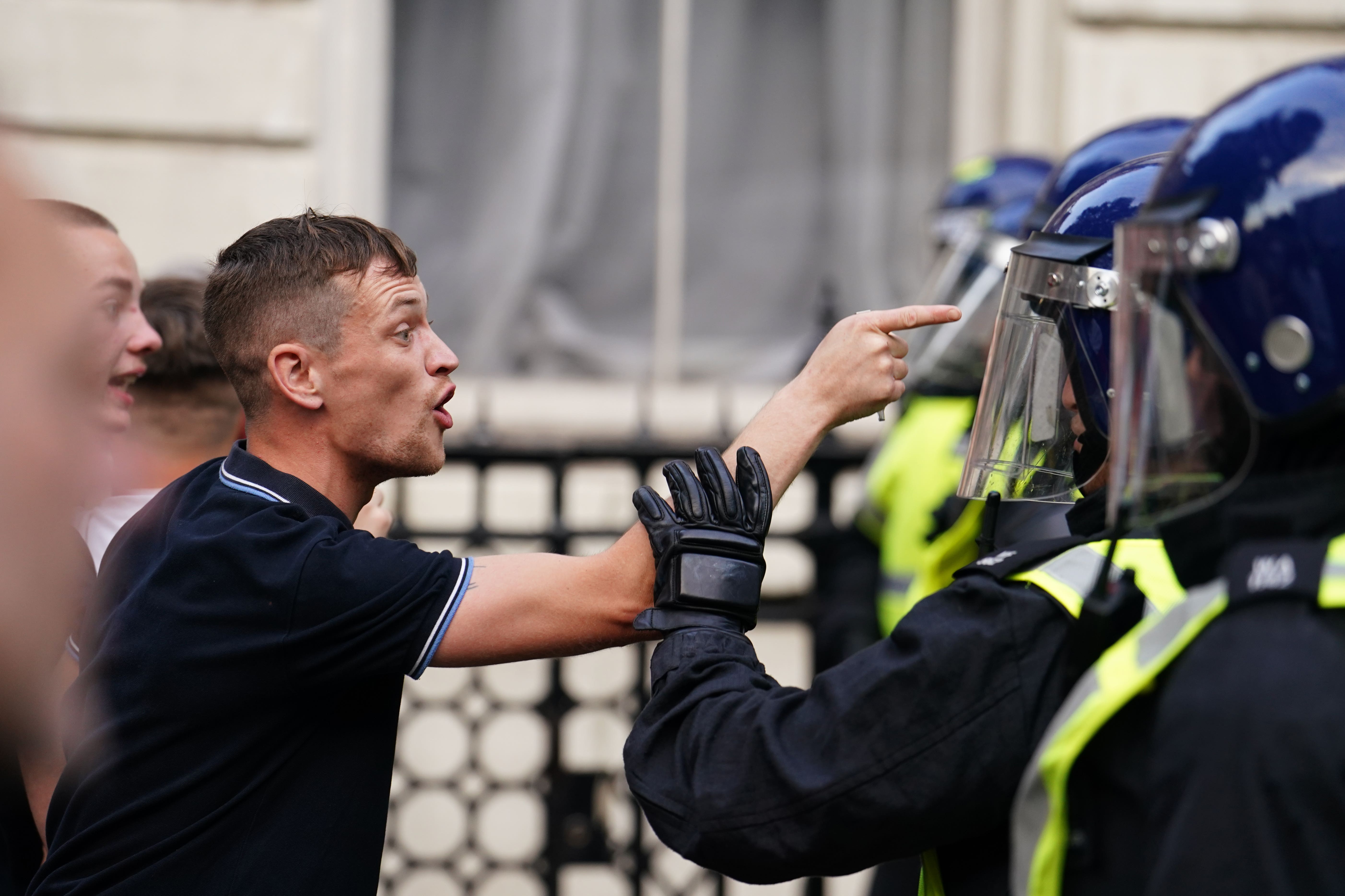 Police officers face off with people attending the Enough is Enough protest in Whitehall, London on Wednesday (Jordan Pettitt/PA)