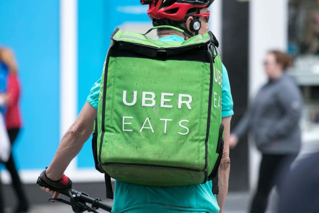 <p>An Uber Eats courier</p>