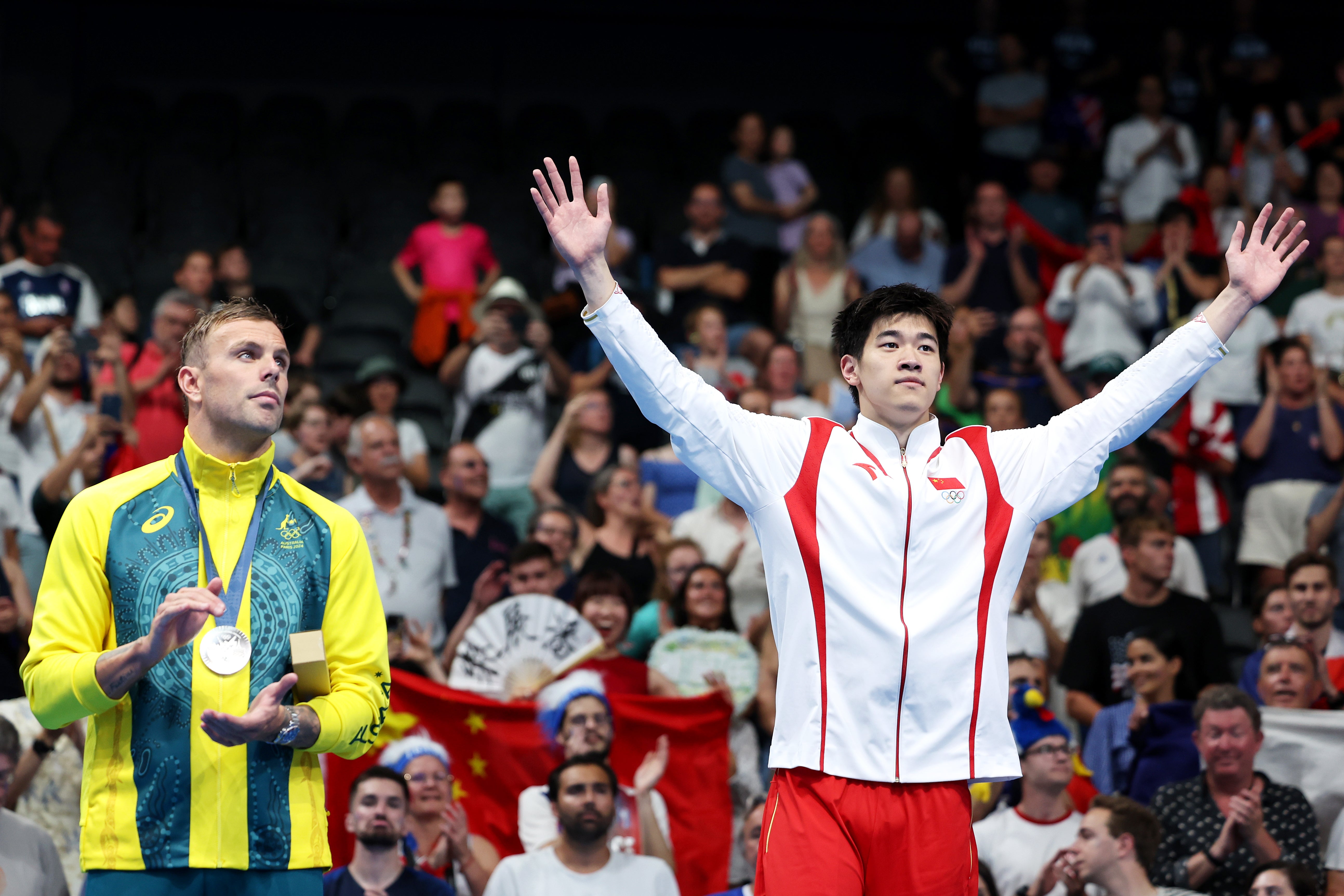 Kyle Chalmers applauds as Pan Zhanle steps on to the Olympic podium