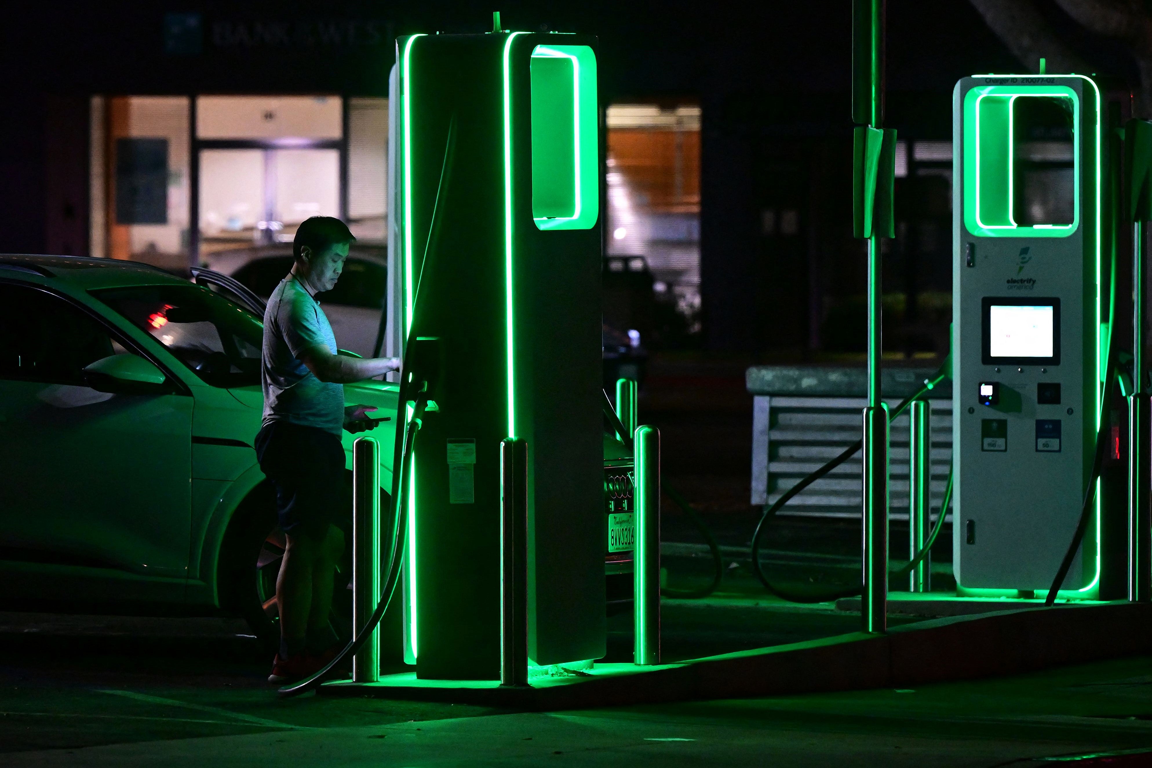 A driver charges his electric vehicle at a charging station in Monterey Park, California on 31 August, 2022