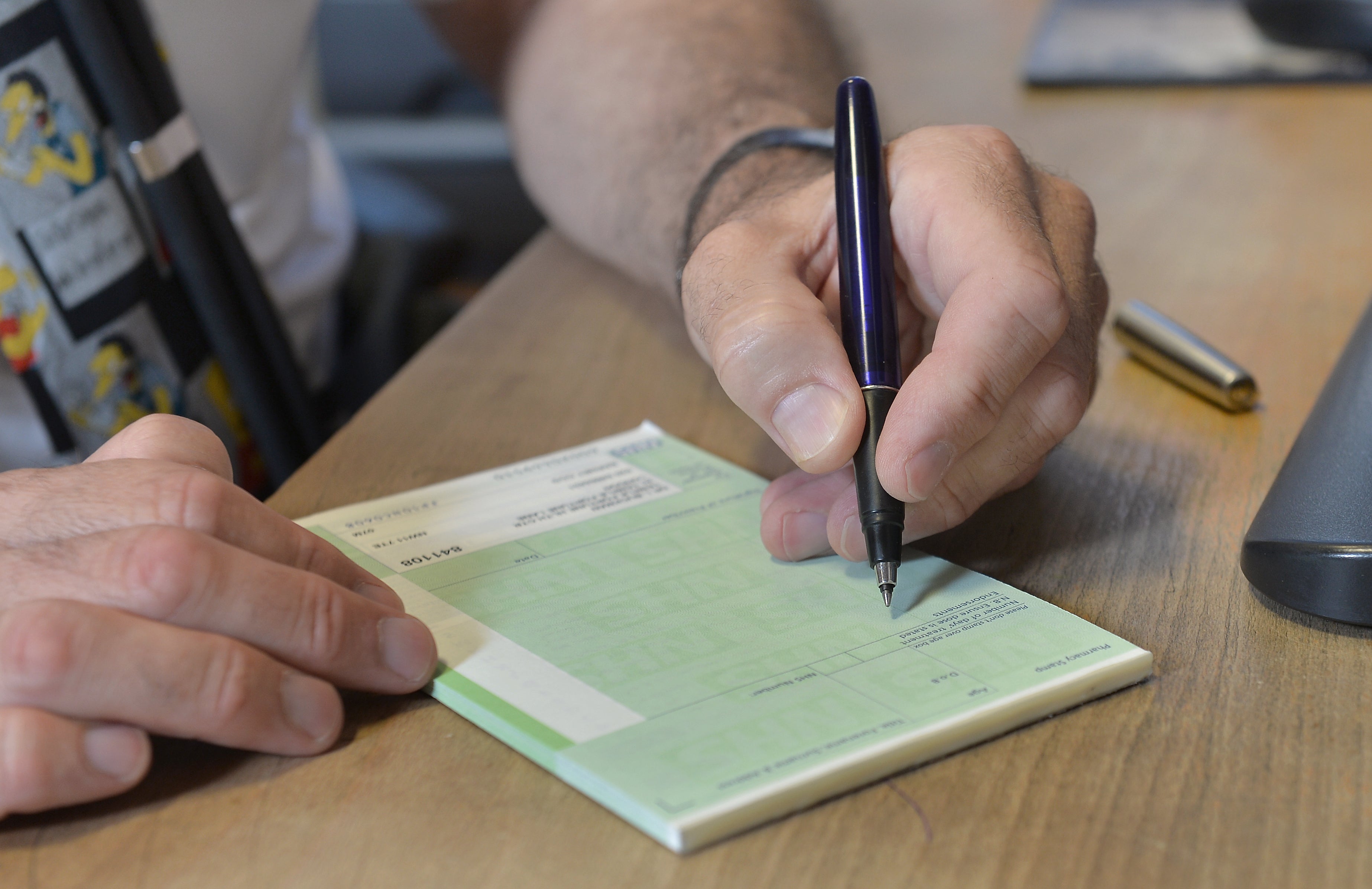 A GP writes a prescription (Anthony Devlin/PA)