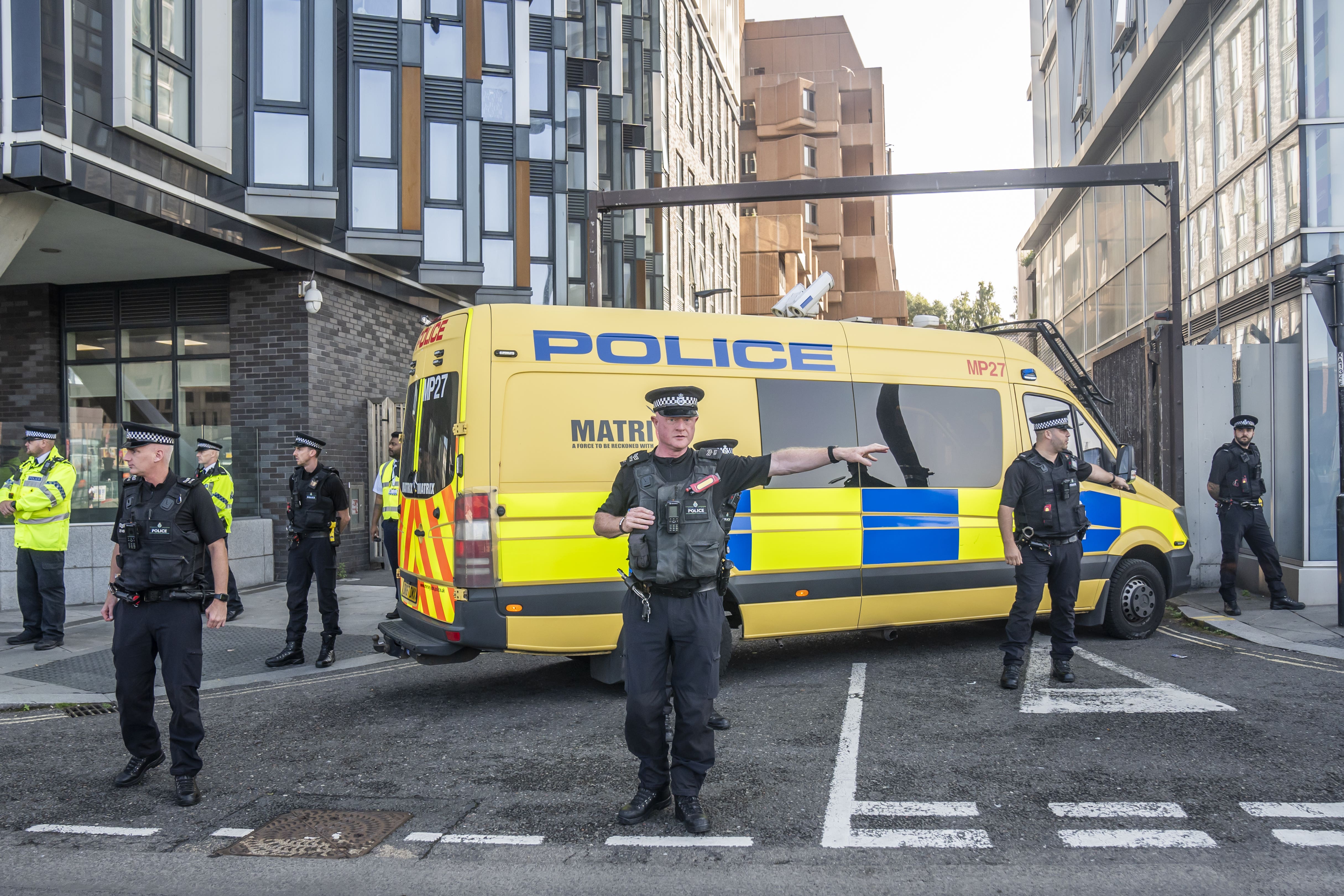 Police officers and a police van block the vehicle entrance at Liverpool Magistrates’ Court (Danny Lawson/PA)