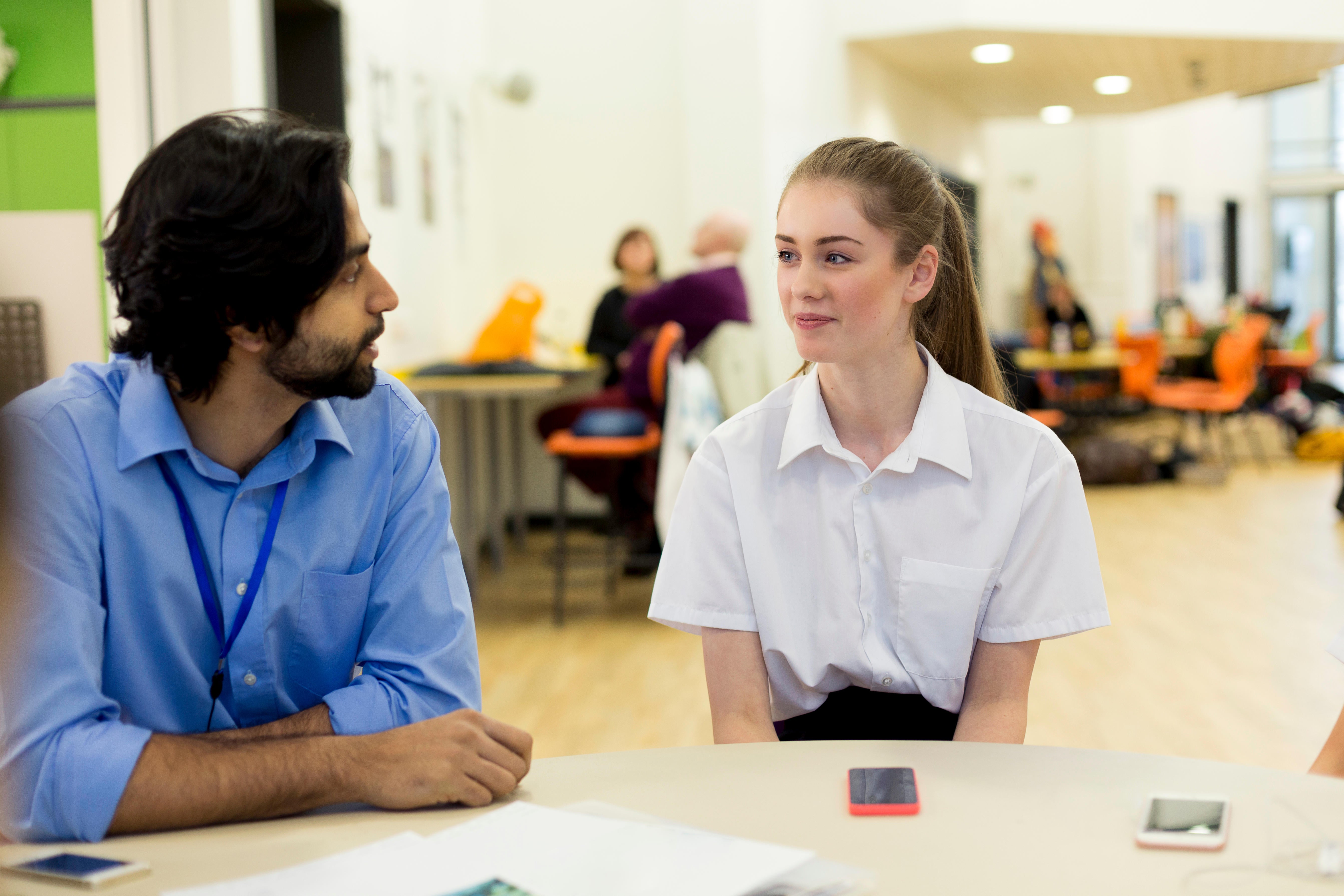 A teacher talks to a student. There stress of the job means few stay on until retirement age