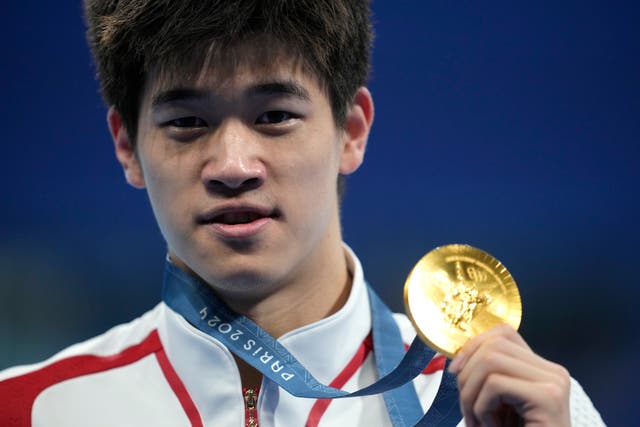 <p>Gold medalist Pan Zhanle, of China, poses after the men’s 100-meter freestyle final</p>
