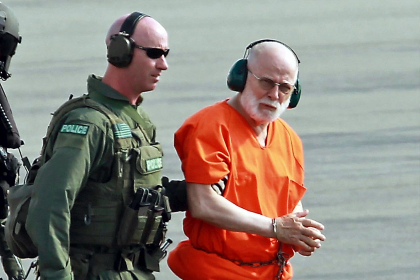 In this June 2011 photo, James "Whitey" Bulger is escorted from a Coast Guard helicopter to a waiting vehicle at an airport in Plymouth, Massachusetts. Bulger was beaten to death in prison in October 2018