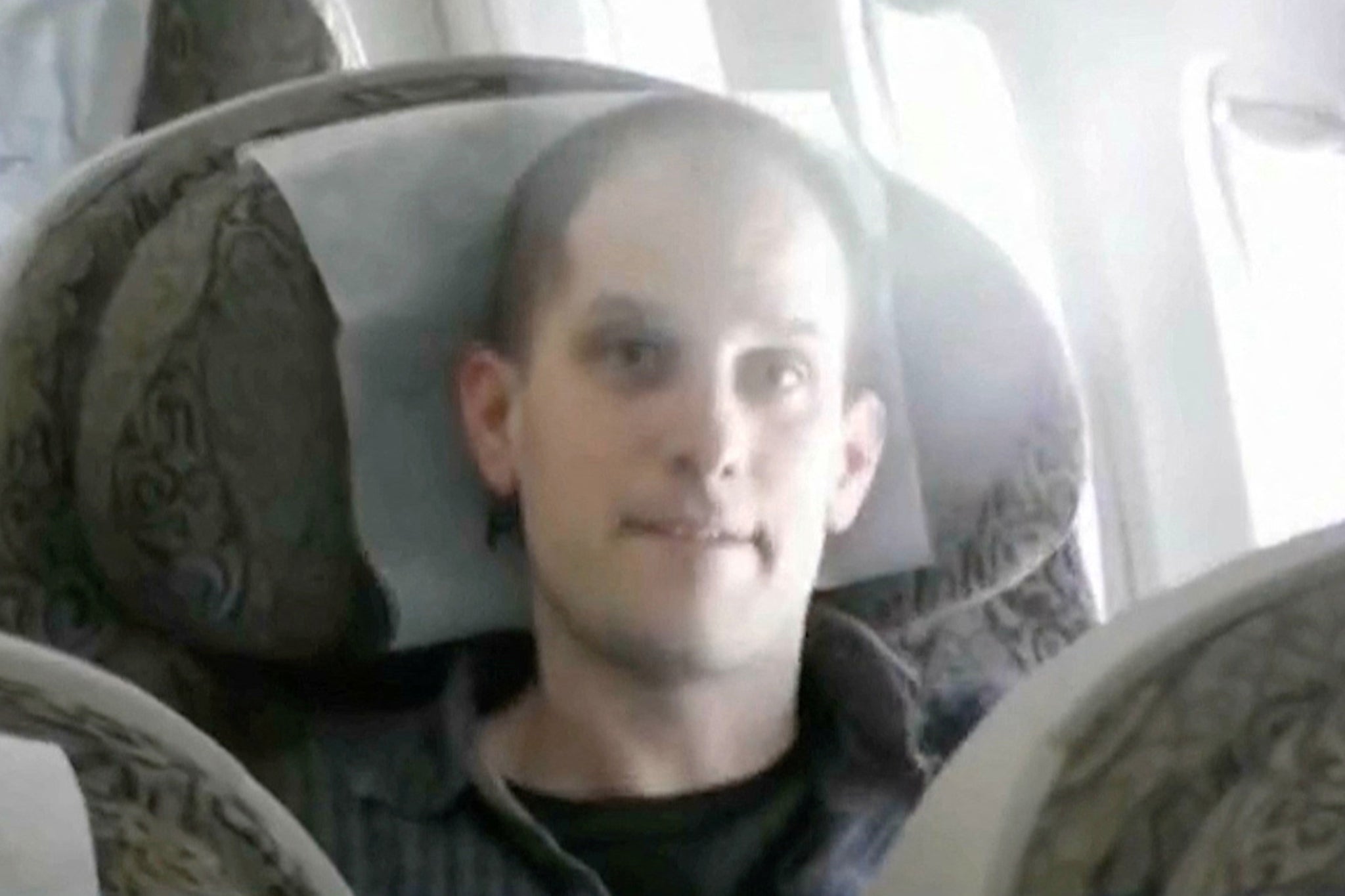 US journalist Evan Gershkovich is seen inside a plane during a prisoner exchange between Russia with Western countries at an undisclosed location