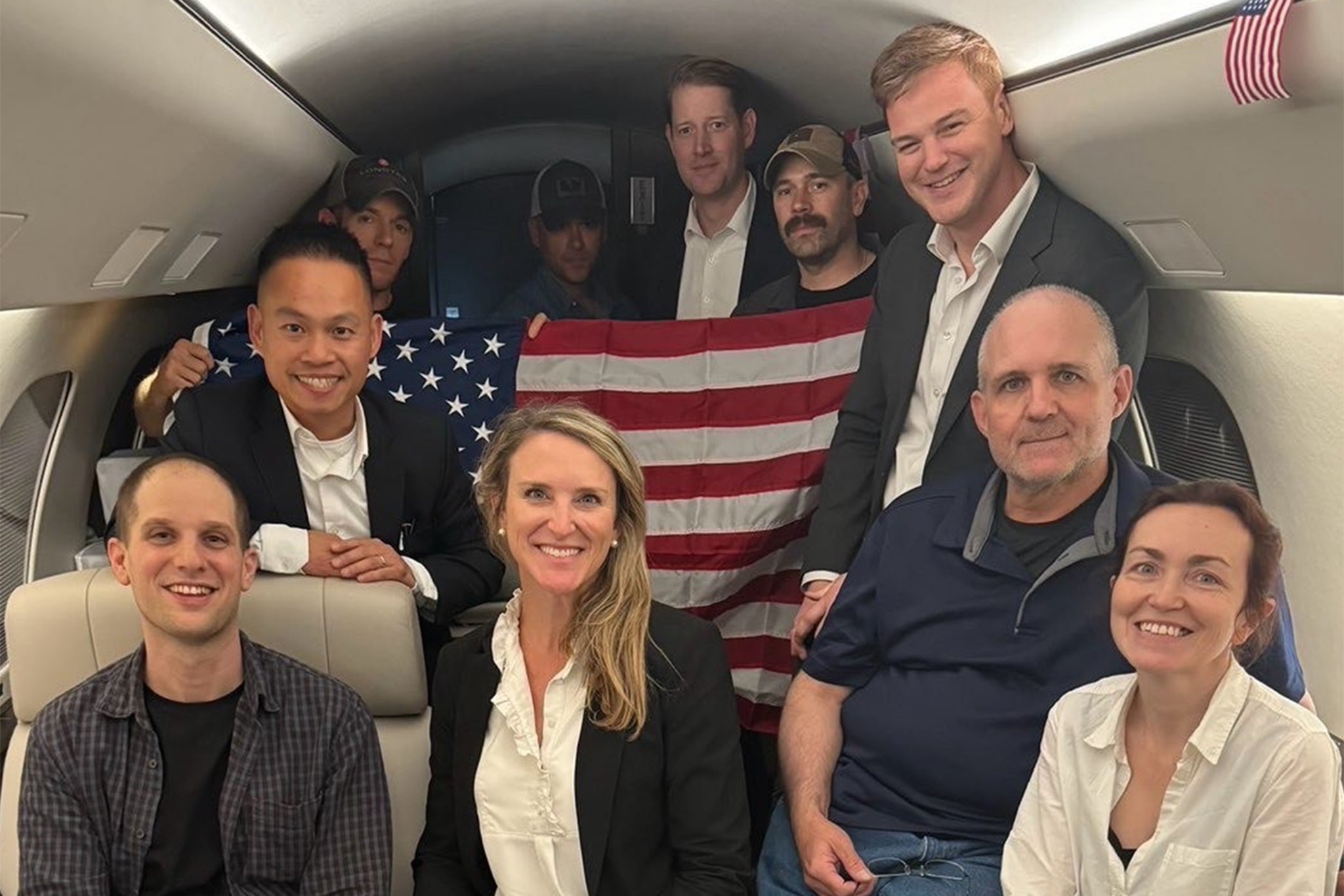 In this image released by the US Government, US journalist Evan Gershkovich (L), former US Marine Paul Whelan (2R) and US-Russian journalist Alsu Kurmasheva (R) are seen on a plane after their release from Russia