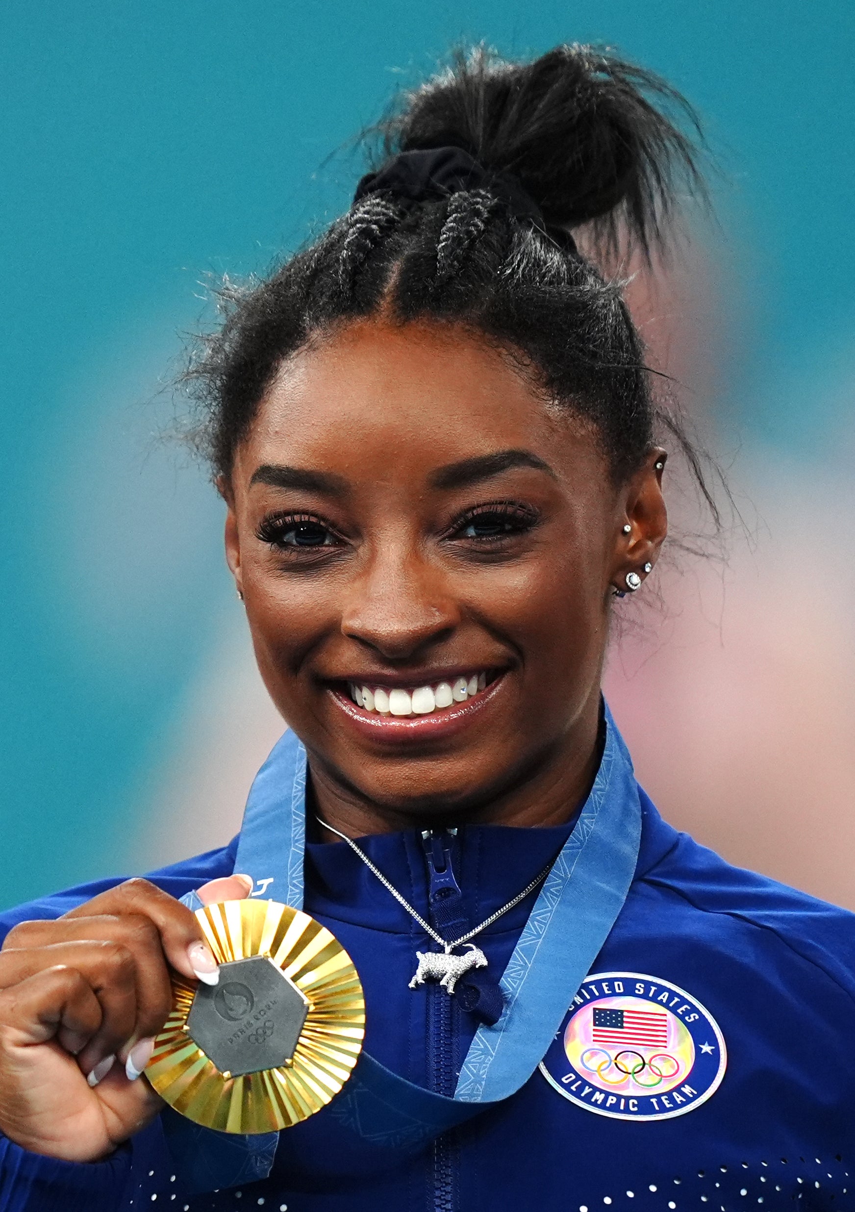 Biles with her gold medal and sporting a silver goat necklace (Mike Egerton, PA)