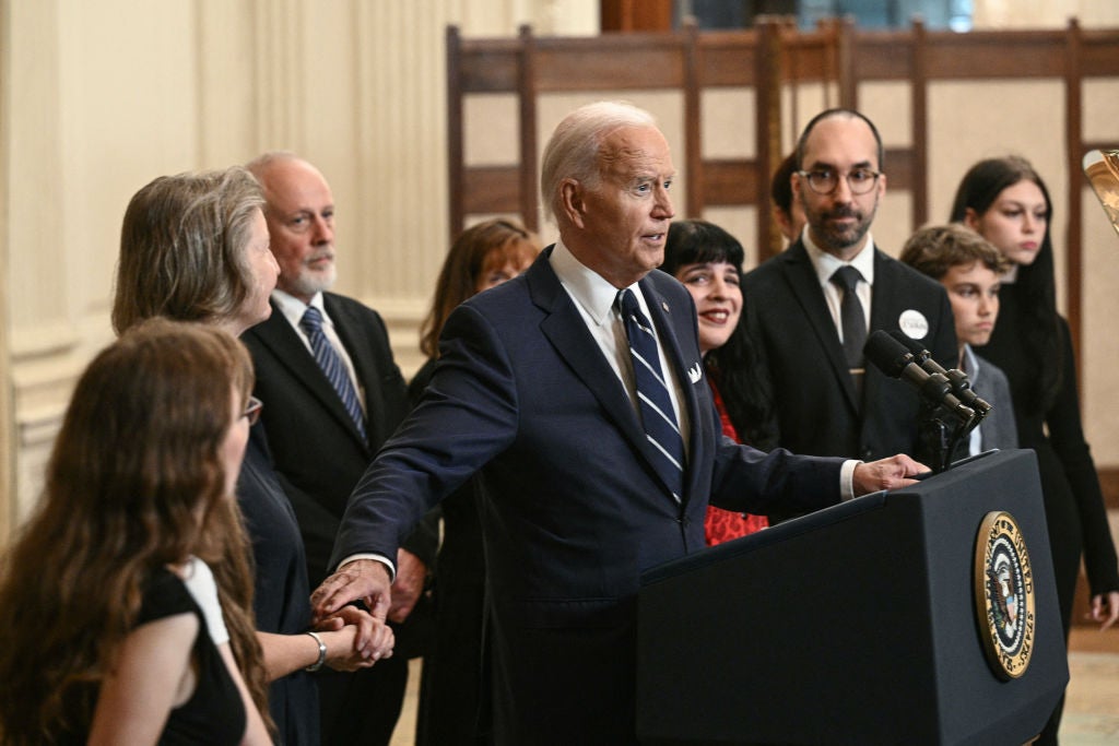 Joe Biden speaks with family members of freed Russian prisoners in the White House state dinner room on August 1.