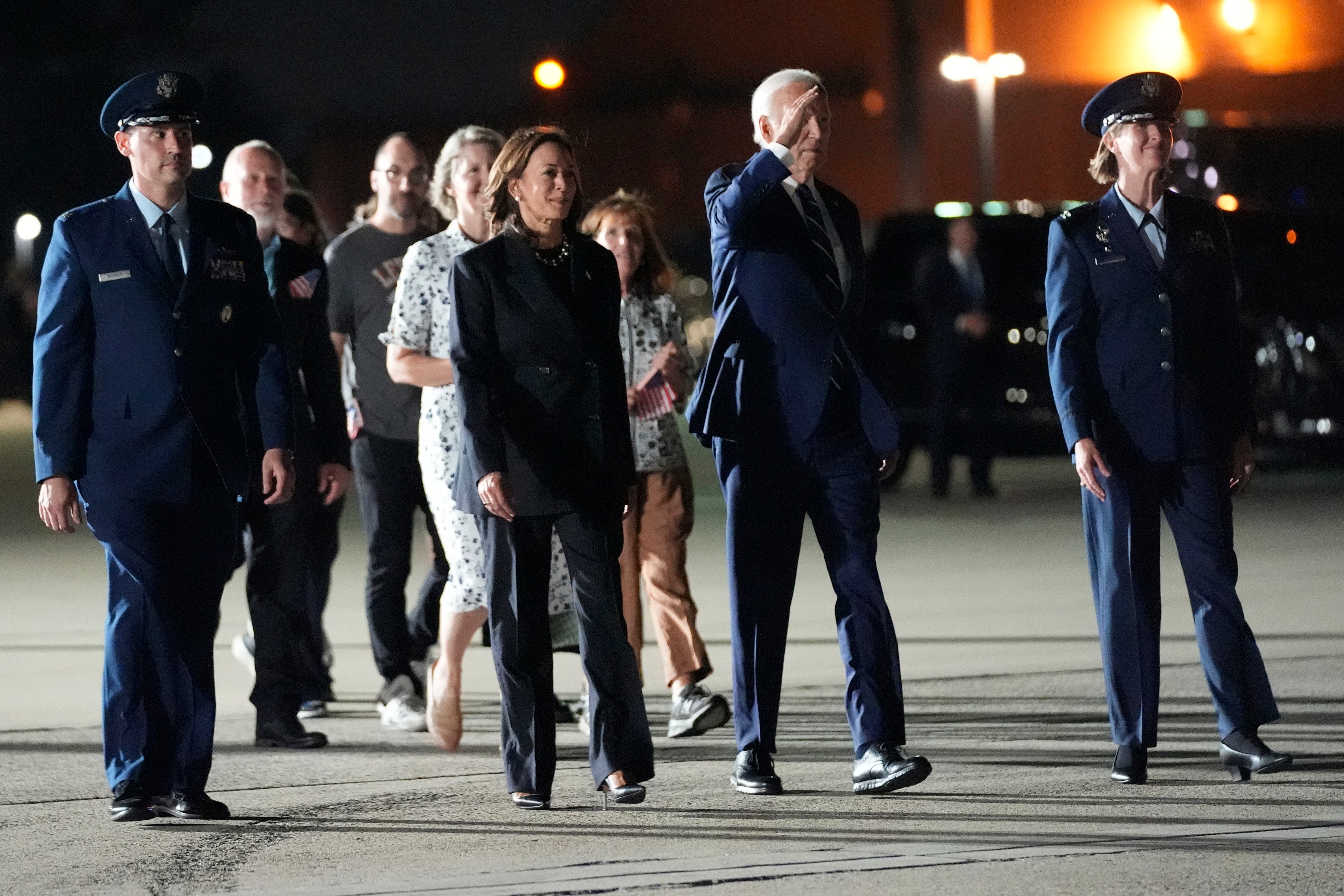 President Joe Biden, center right, and Vice President Kamala Harris, center left, walk to greet reporter Evan Gershkovich, Alsu Kurmasheva and Paul Whelan at Andrews Air Force Base