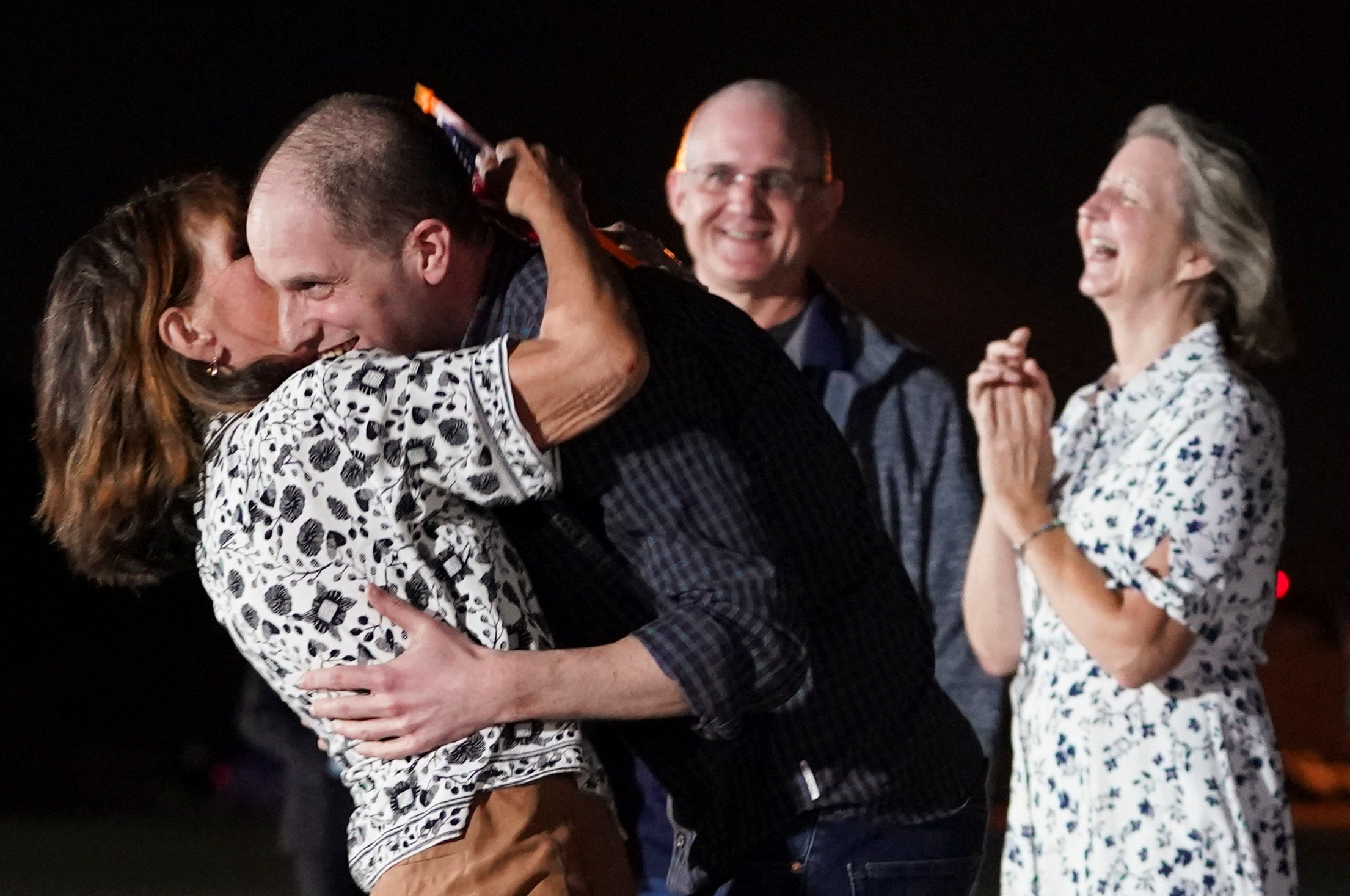 US journalist Evan Gershkovic, who was released from detention in Russia, is embraced by his mother Ella Milman