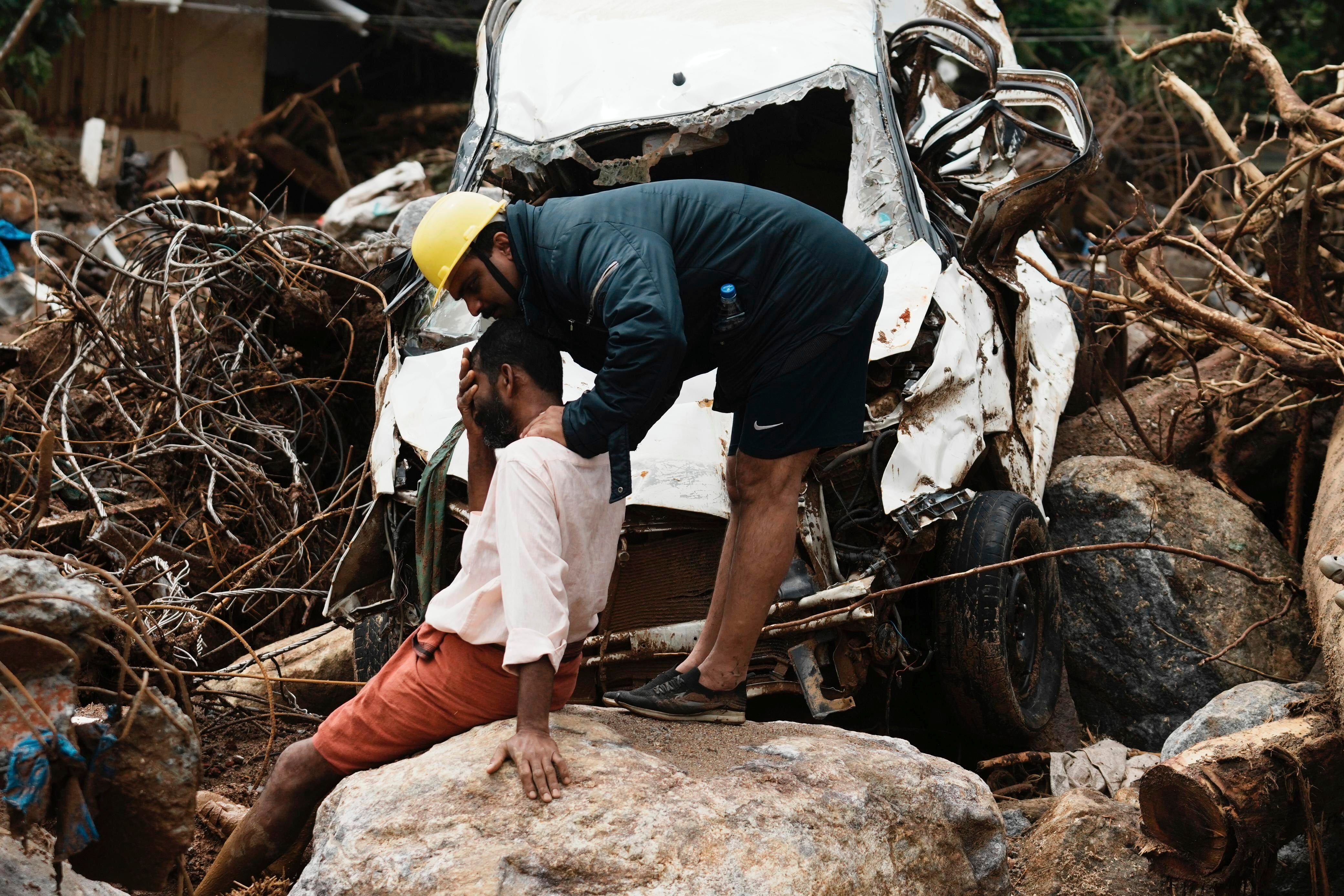 <p>A rescue worker consoles a man who lost his home in the Wayanad landslides in Kerala, on 31 July 2024</p>