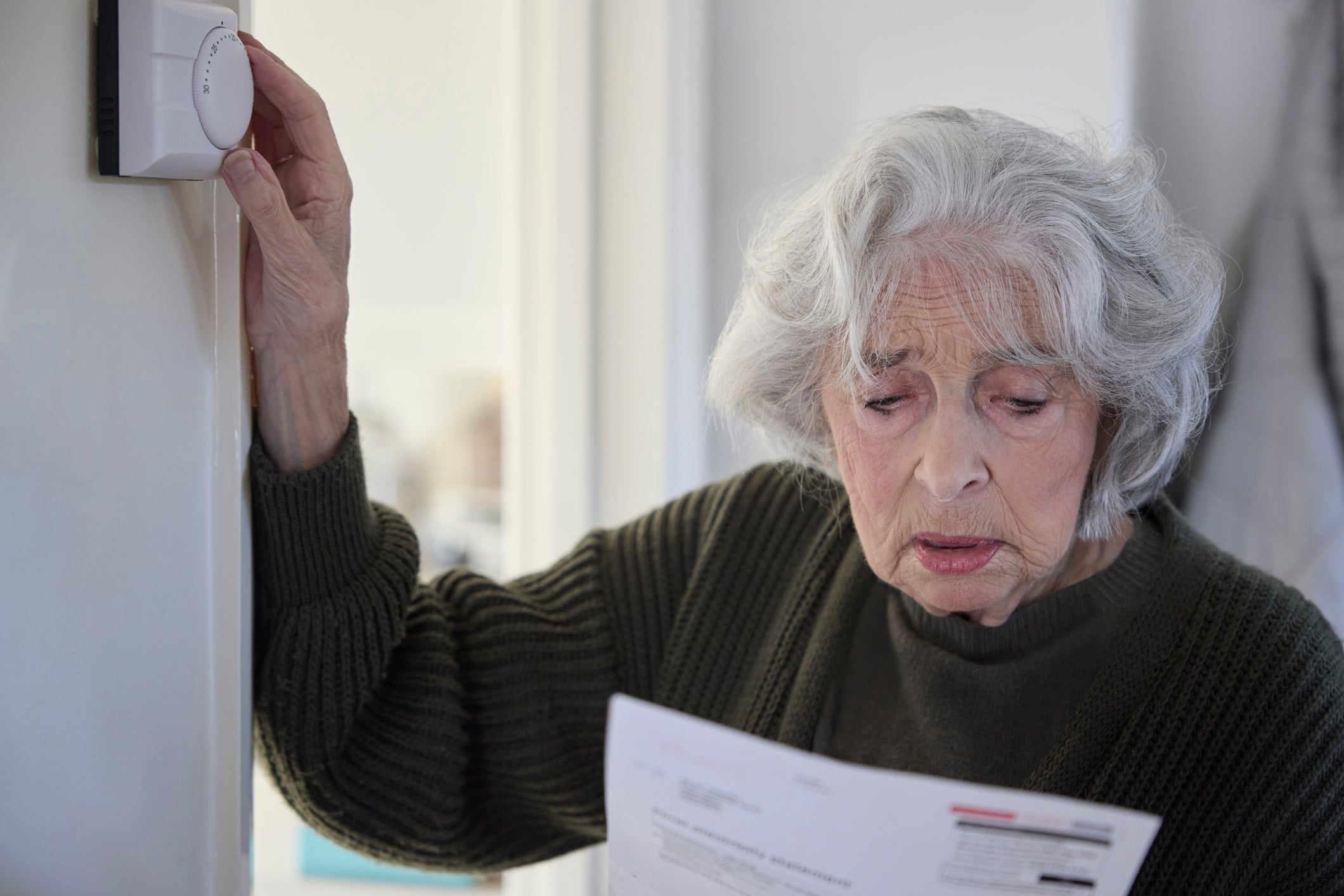 A worried woman looking at her energy bill (stock image)