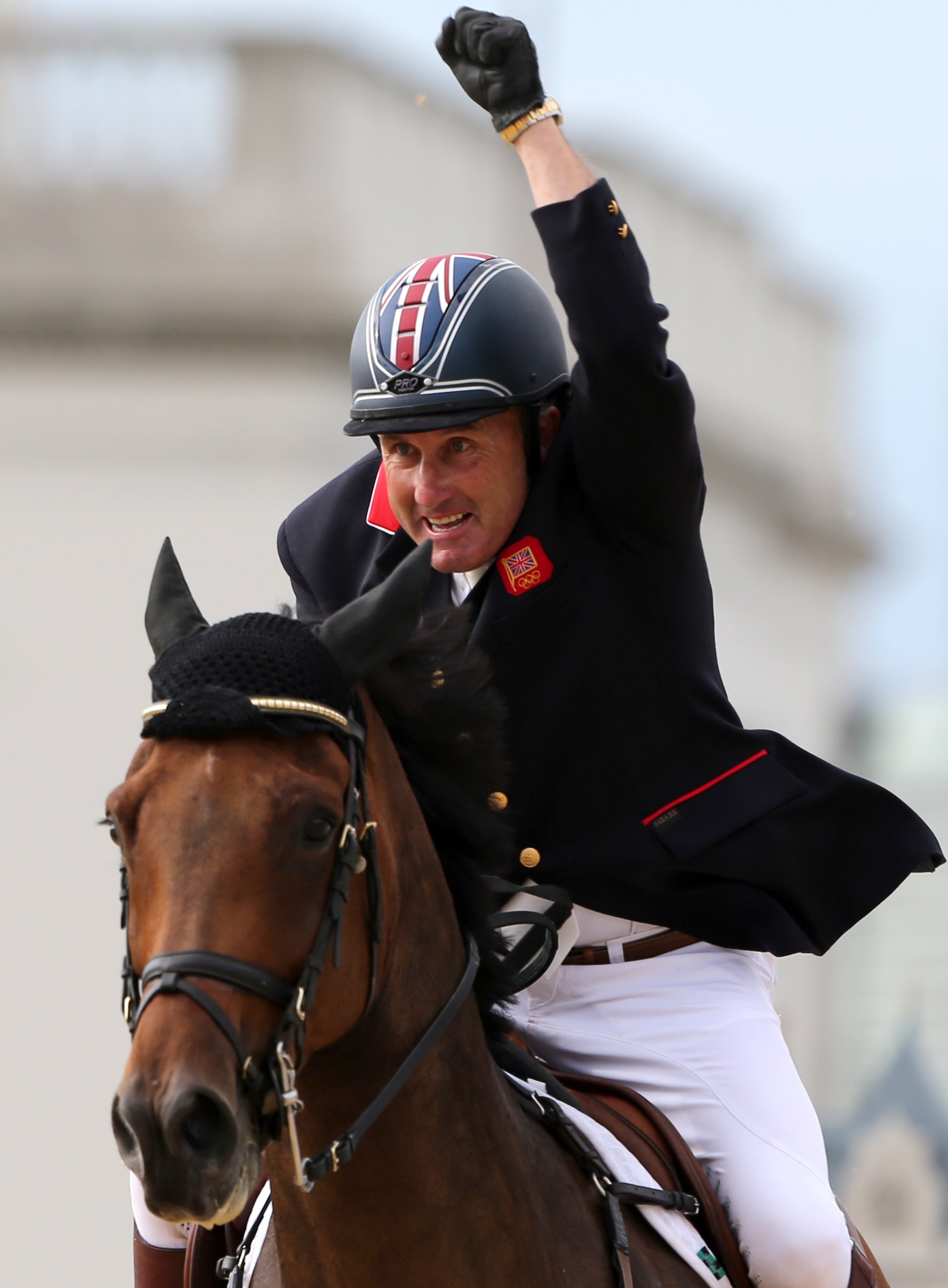 Peter Charles, Harry’s father, punches the air after riding Vindicat to gold in London in 2012 (PA)