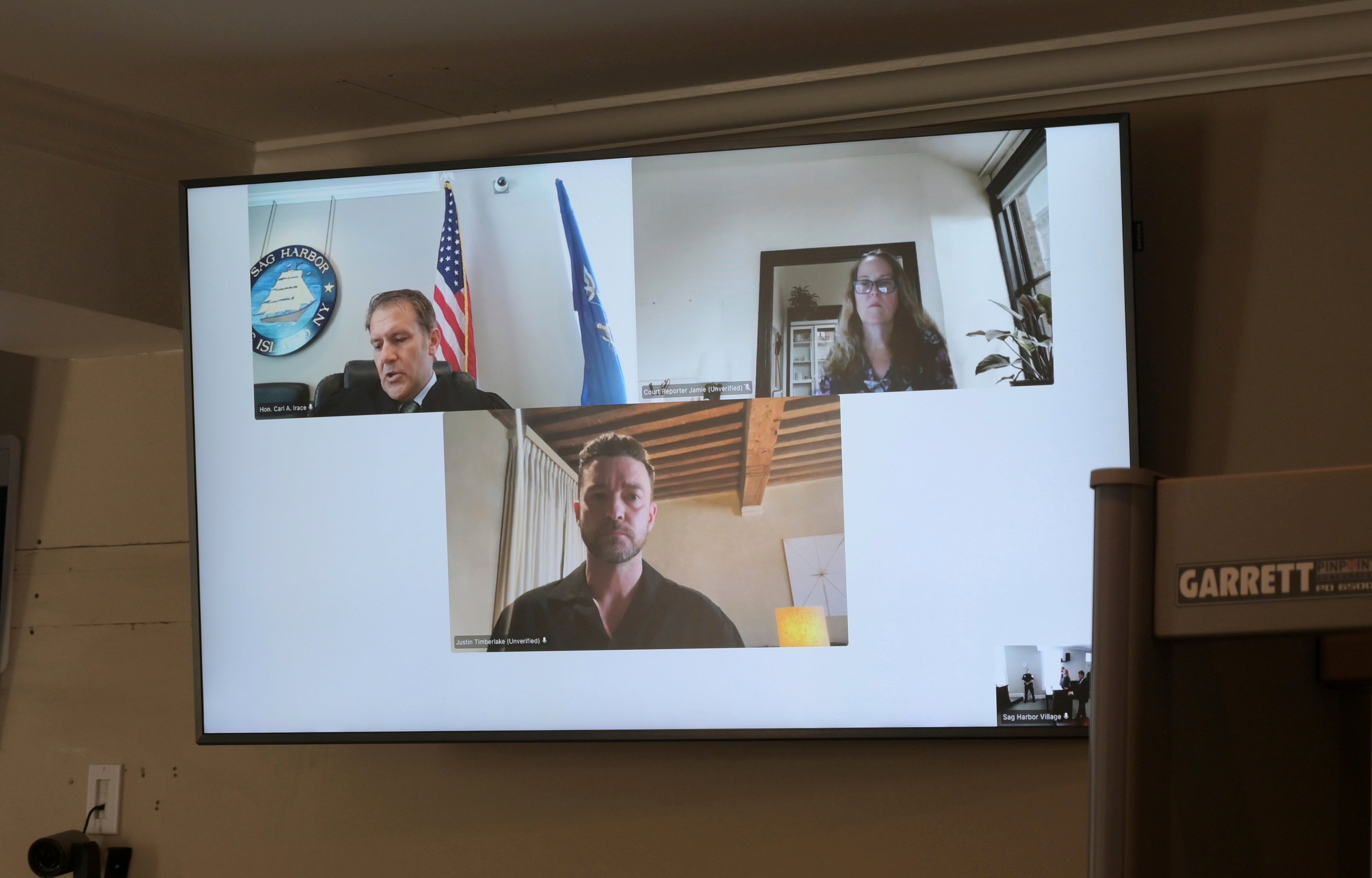 Justin Timberlake, center, appearing by video during his arraignment in Sag Harbor Justice Carl Irace’s courtroom on Friday, August 2