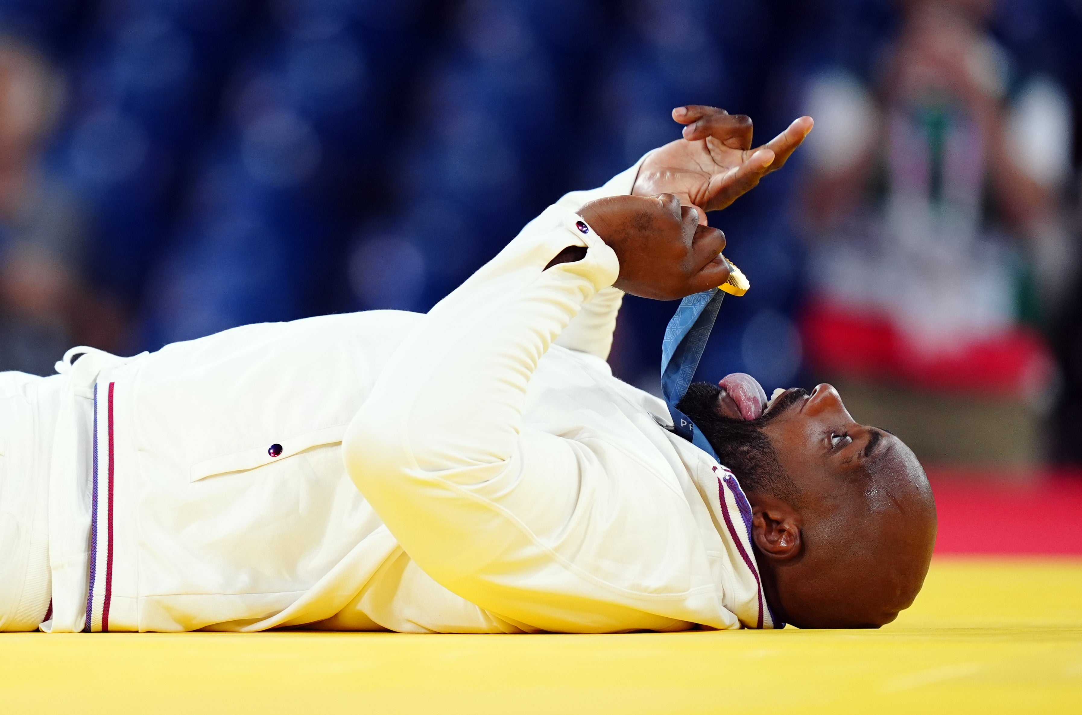 Teddy Riner celebrates with his fourth Olympic gold medal