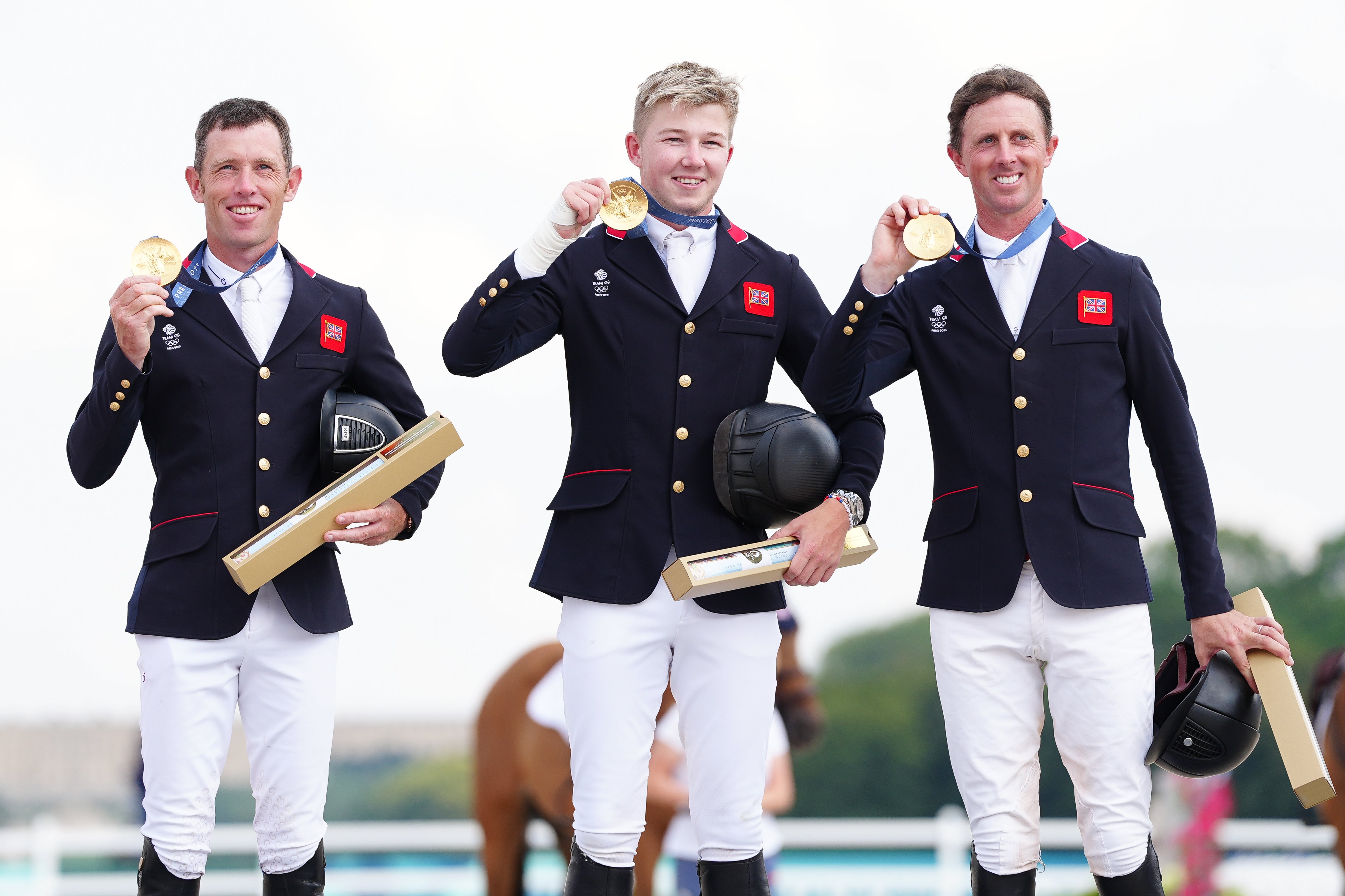 Harry Charles (centre) followed in the footsteps of his father, Peter, in winning Olympic gold (David Davies/PA)