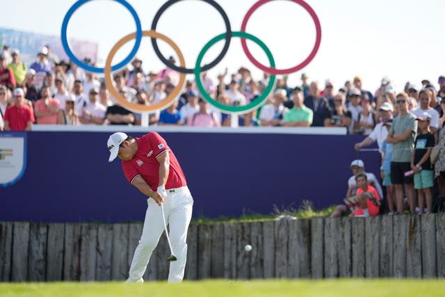 <p>Tom Kim tees off on the first hole at Le Golf National</p>