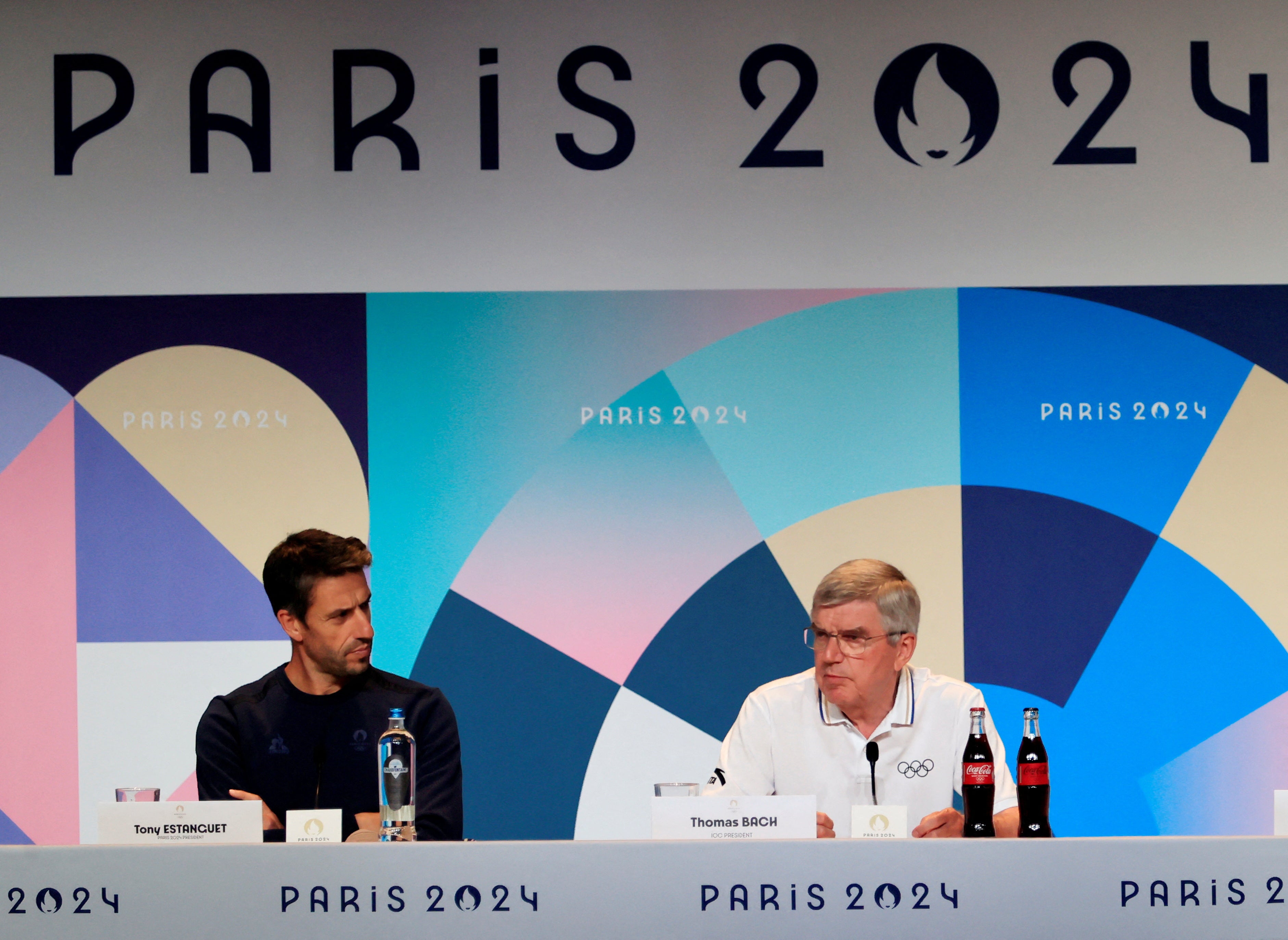 Thomas Bach, right, addresses reporters at a press conference in Paris