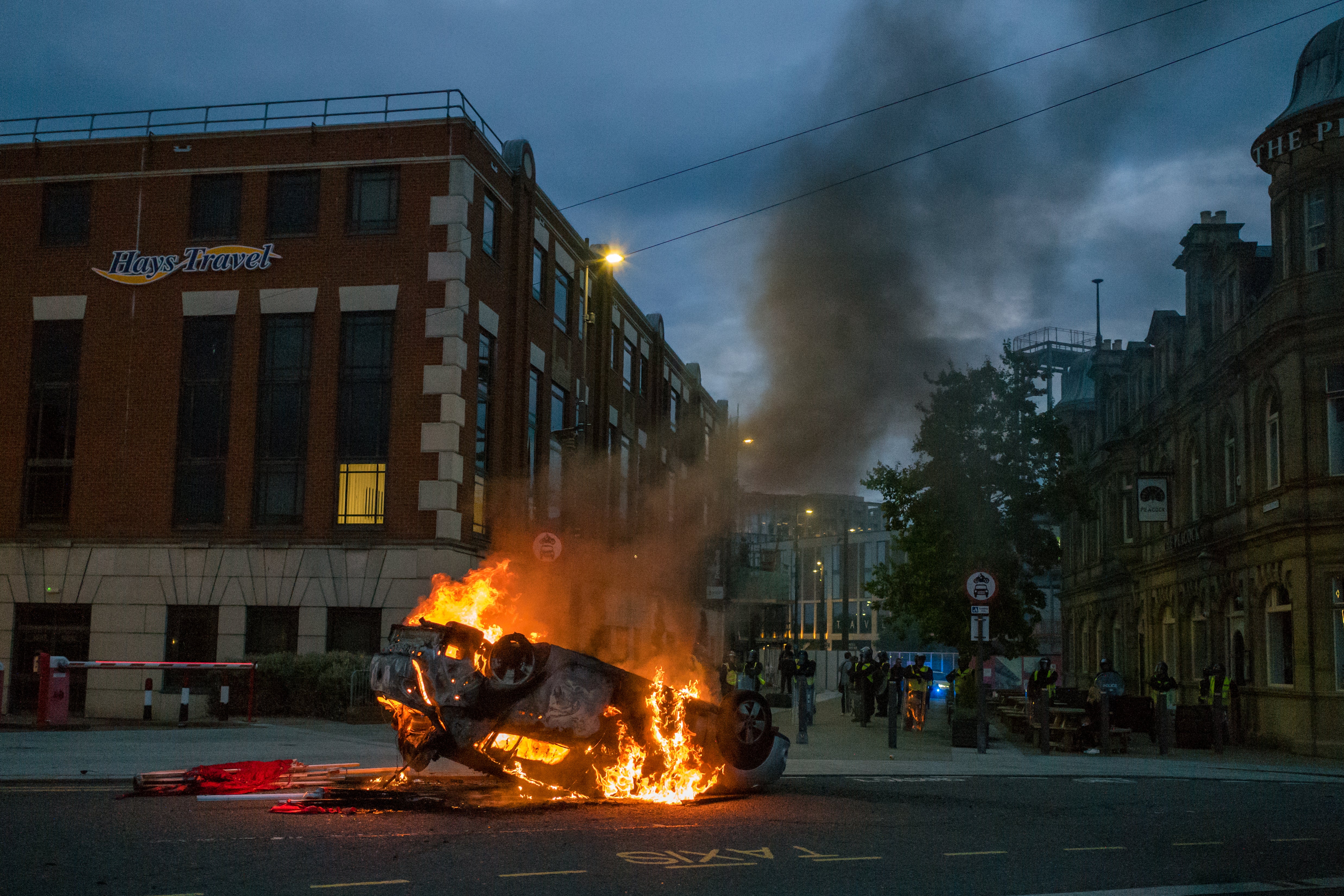 A car set on fire during the disturbances