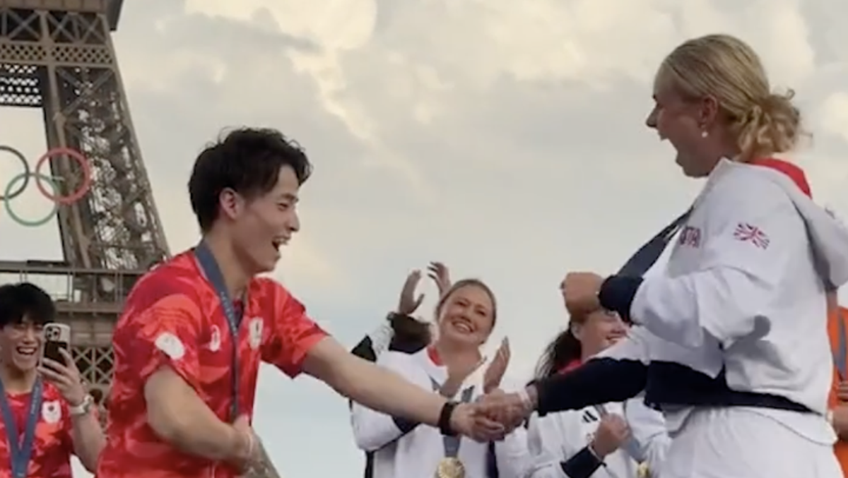 British and Japanese Olympic gold medallists dance together in celebration under Eiffel Tower