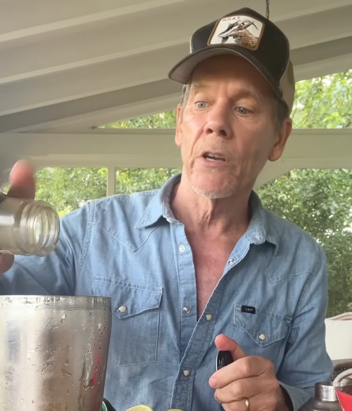 Kevin Bacon preparing a cocktail in honor of Simone Biles