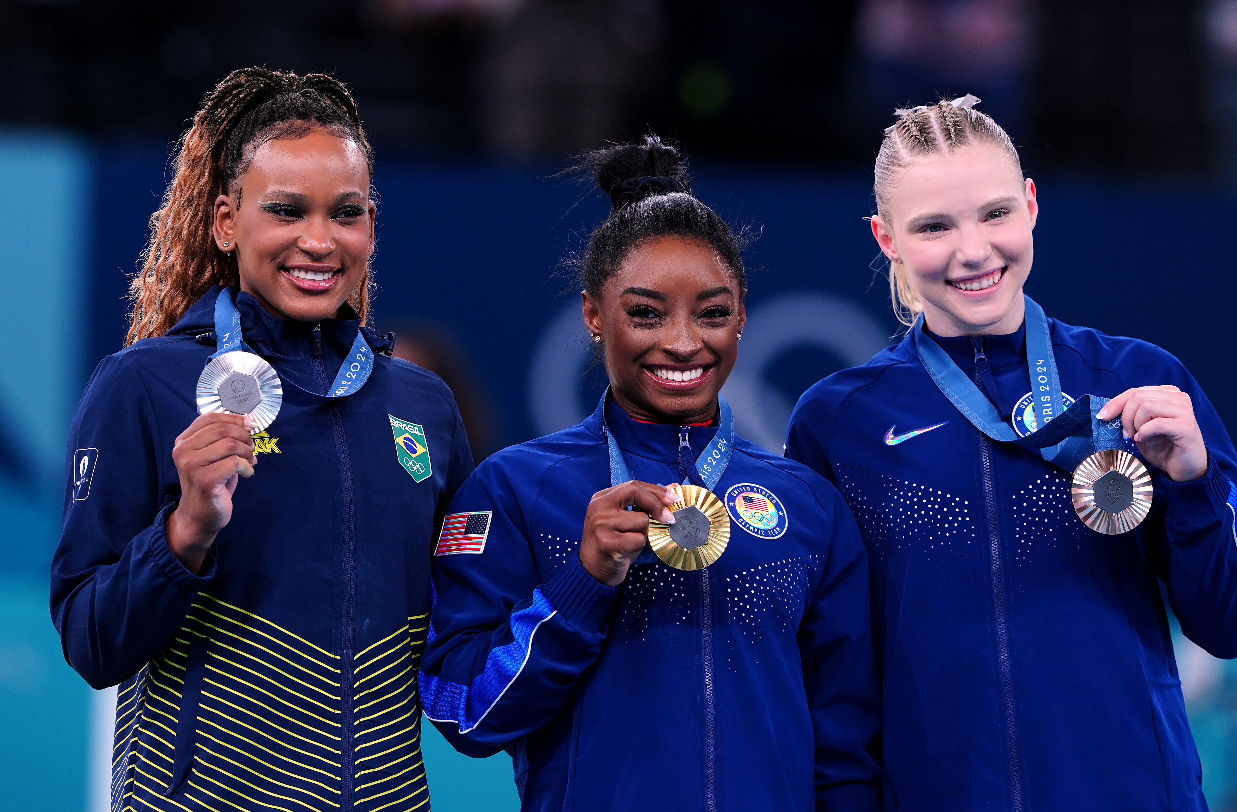 Simone Biles, centre, with fellow medallists Rebeca Andrade, left, and Jade Carey