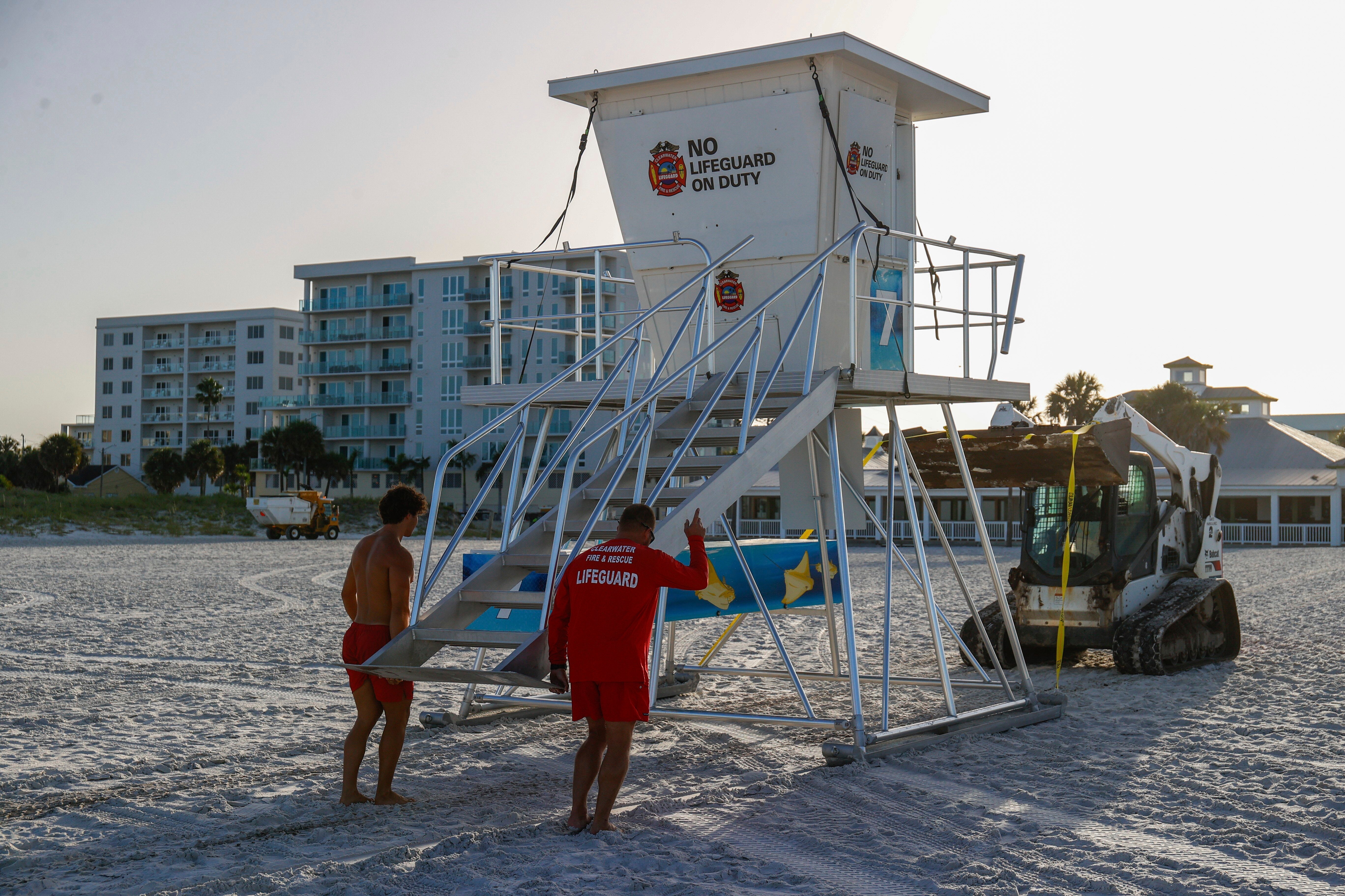 Lifeguards at Clearwater Beach, Florida prepare a lifeguard tower ahead of a tropical depression threatening to strengthen into Tropical Storm Debby