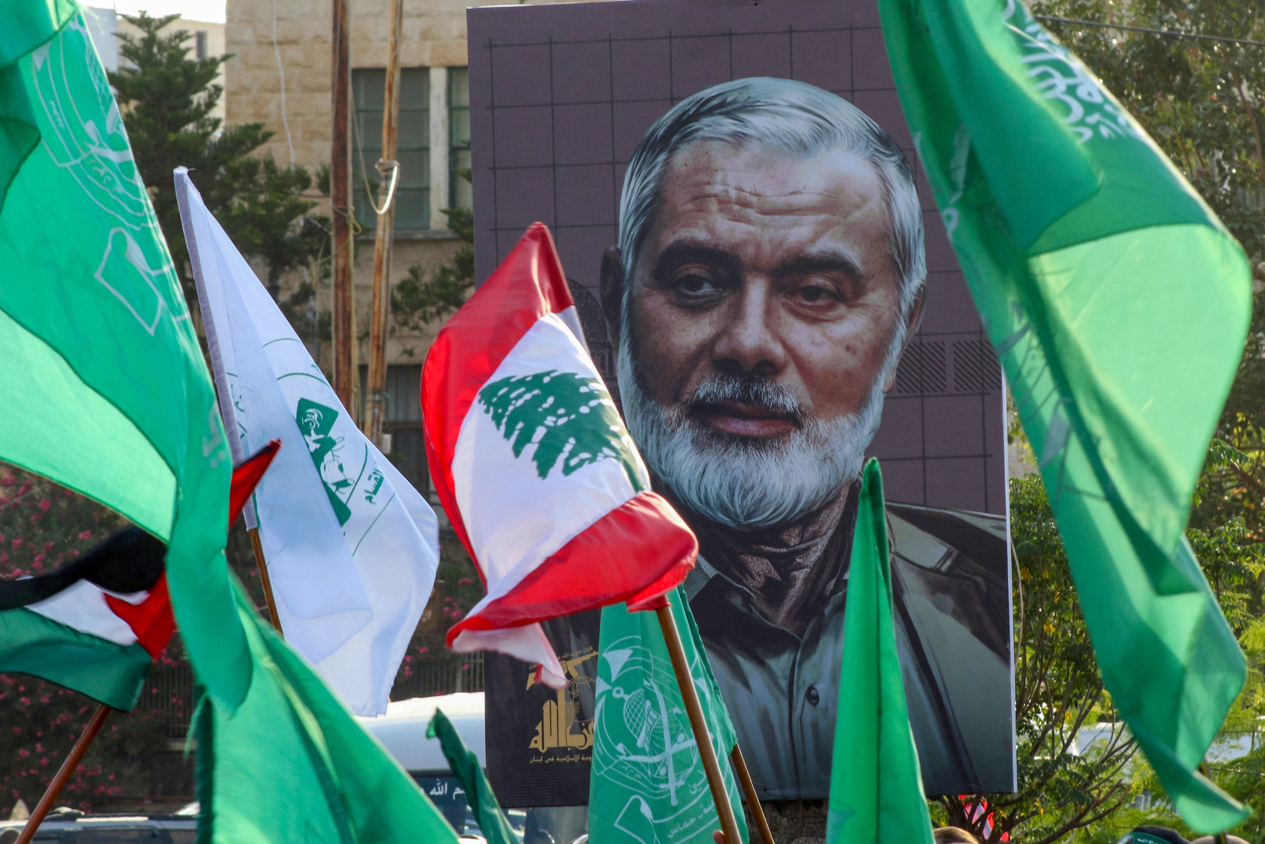 A portrait of slain Hamas leader Ismail Haniyeh is displayed during a a demonstration denouncing his killing and that Hezbollah's senior commander, in the Lebanese coastal city of Sidon