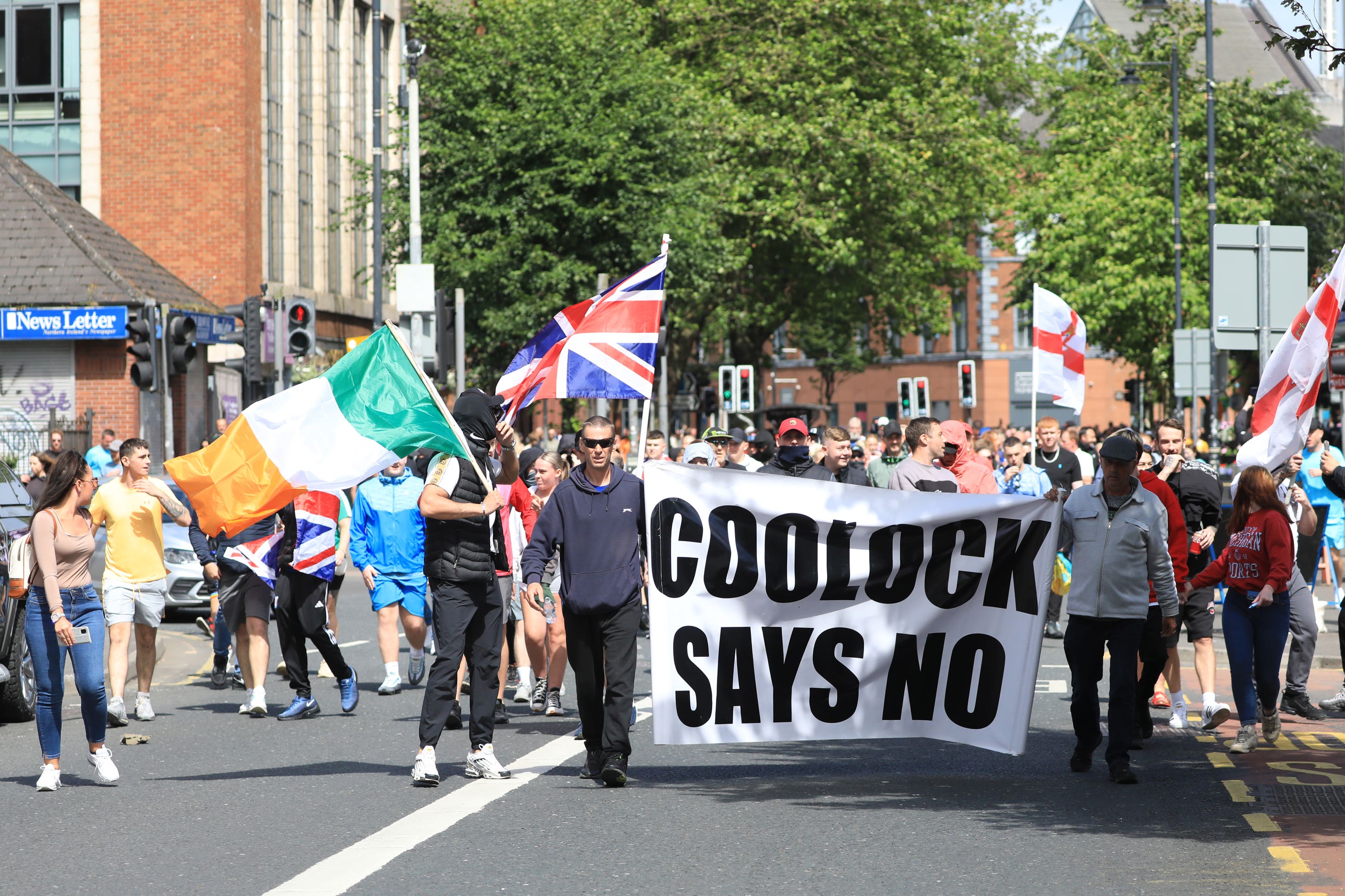 Irish and Union flags were flown side by side at the anti-immigration protest in Belfast on Saturday (Peter Morrison/PA)