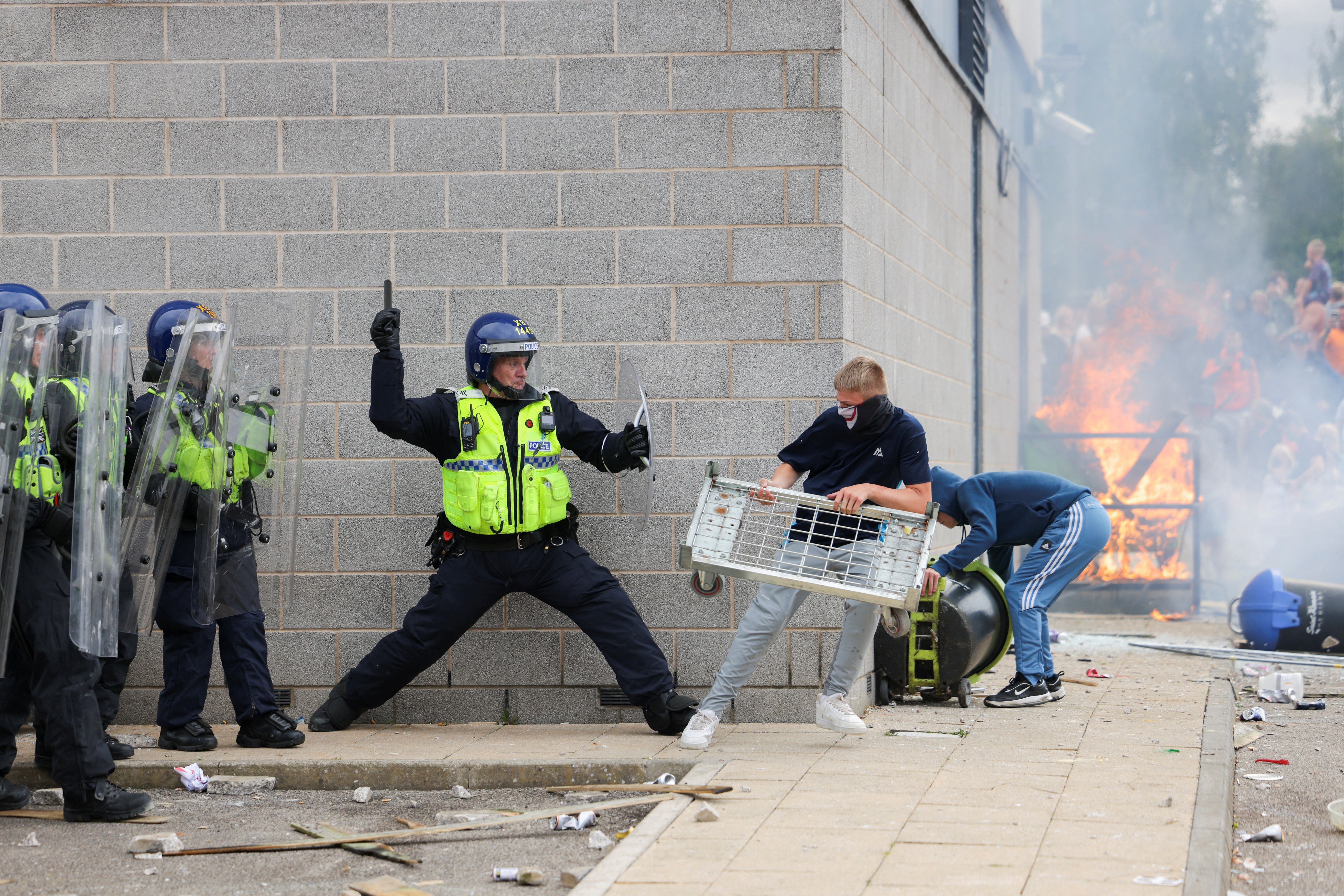 The group clashed with police as a fired raged on the bottom floor of the hotel