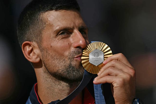 <p>Gold medallist, Serbia's Novak Djokovic kisses his medal</p>