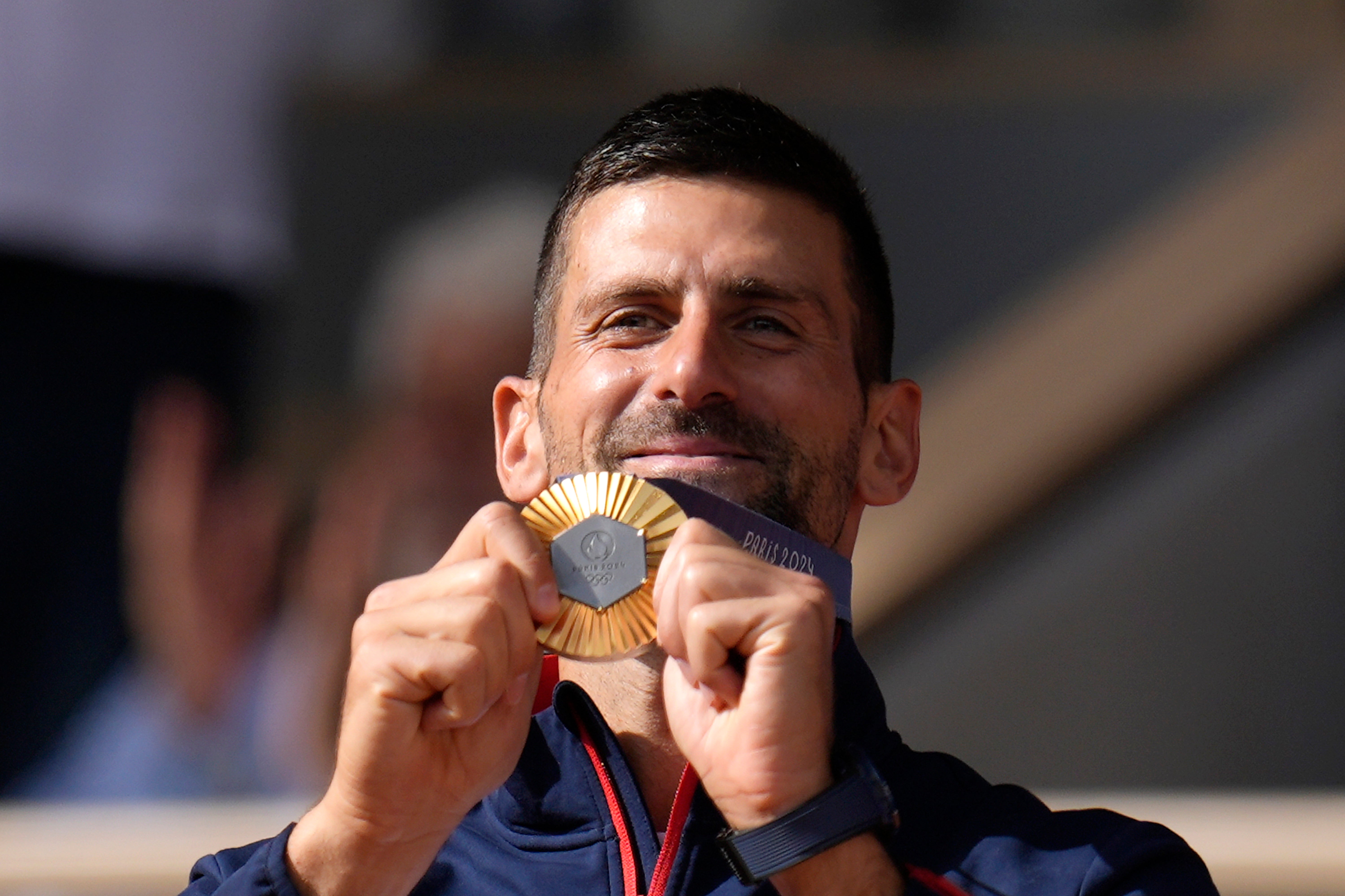 Novak Djokovic shows off his gold medal (Manu Fernandez/AP)