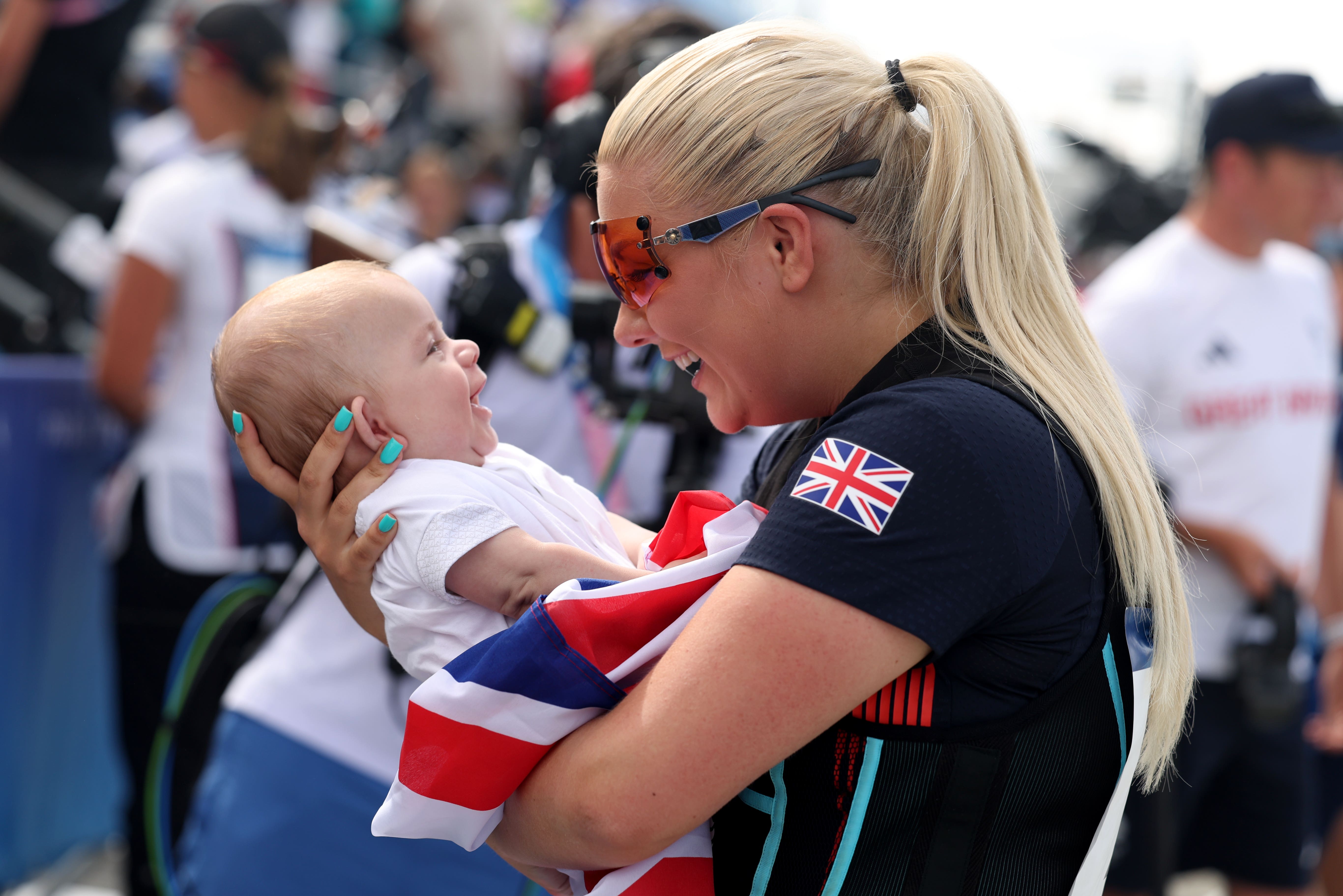 Amber Rutter celebrated with baby son Tommy after winning a shooting silver medal (Isabel Infantes/PA)