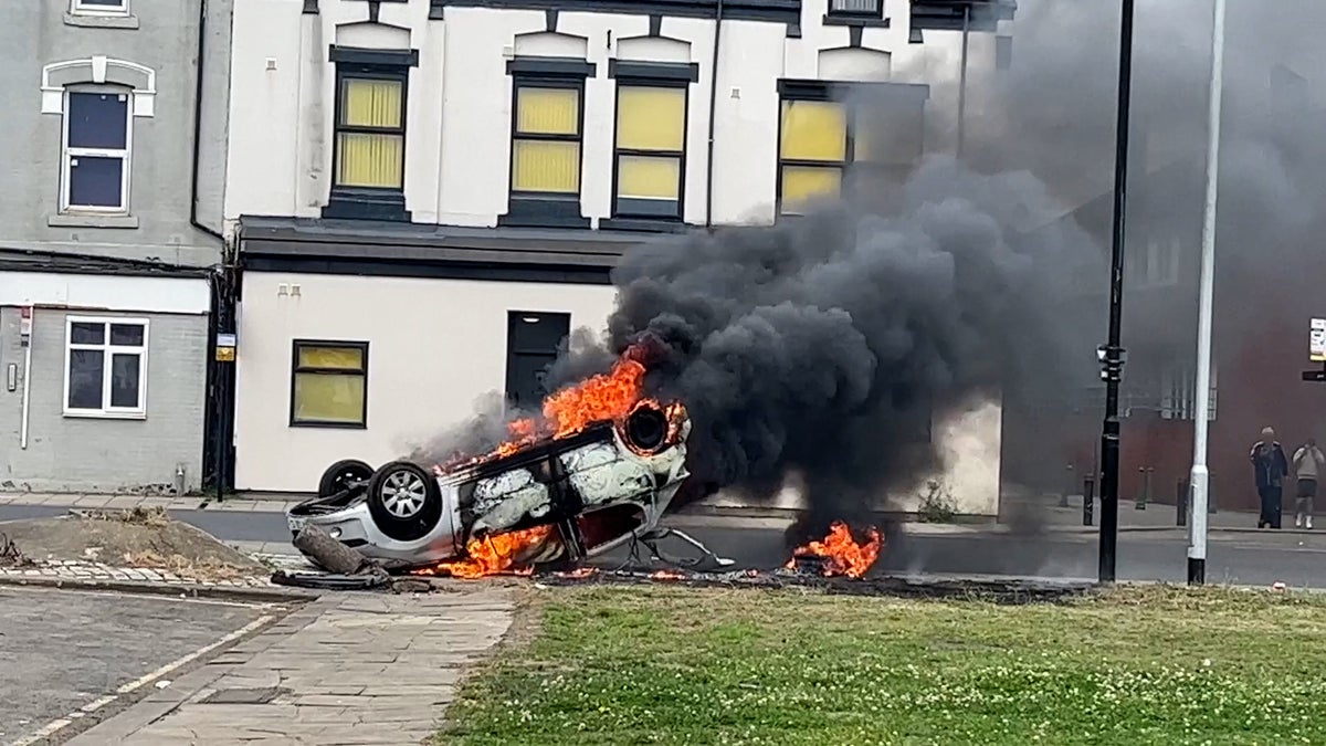 Car set alight after scuffles between police and anti-immigration protesters in Middlesbrough