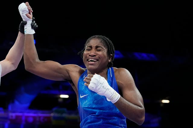 <p>Refugee Olympic Team's Cindy Ngamba celebrates after defeating Canada's Tammara Thibeault</p>