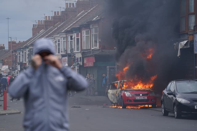 A car burns during an anti-immigration protest in Middlesbrough (Owen Humphreys/PA)