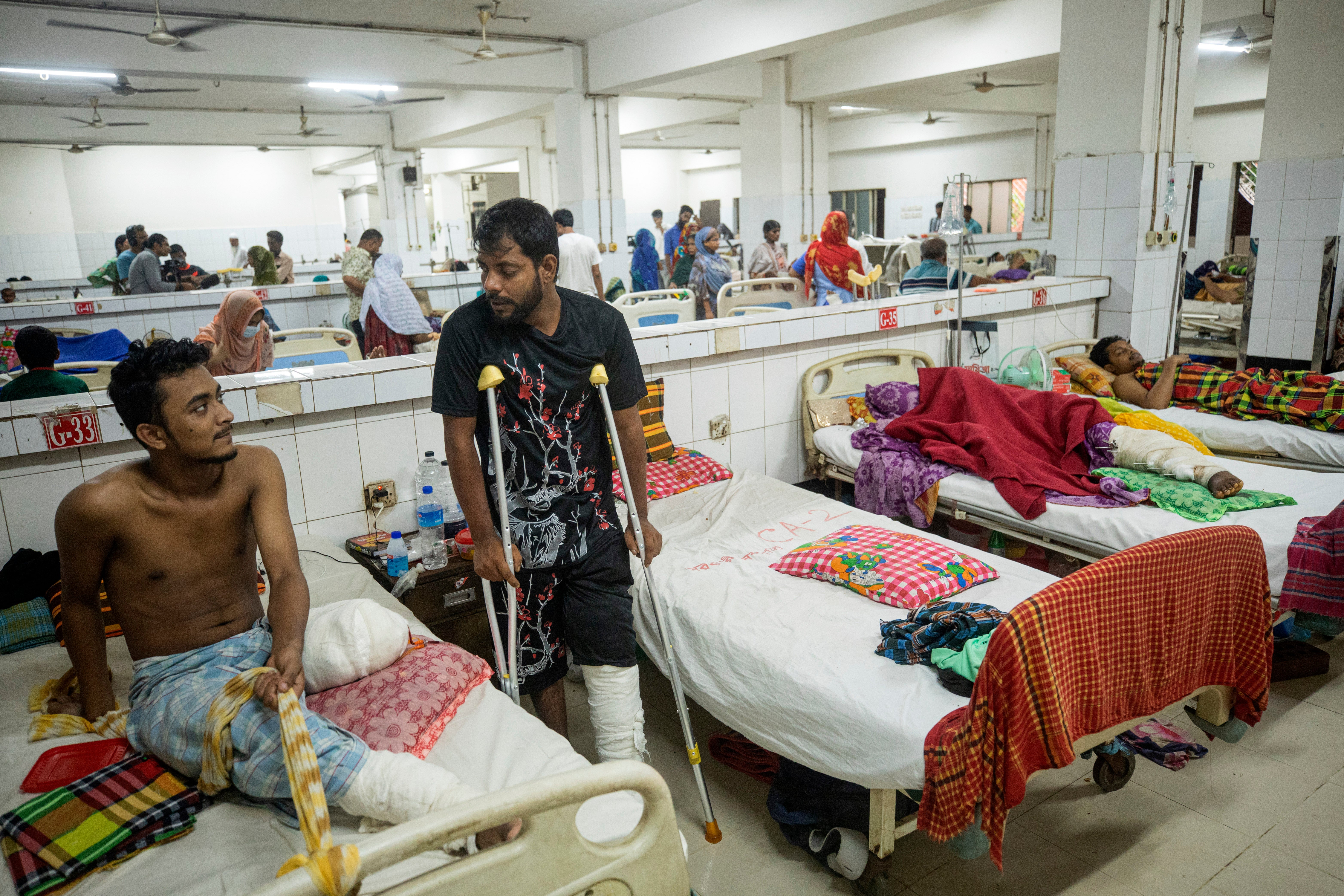 Mohammad Akash, left, lost his leg after taking a bullet during the protests last month