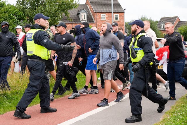 <p>Anti-migration protesters are seen during riots in Manvers, near Rotherham</p>