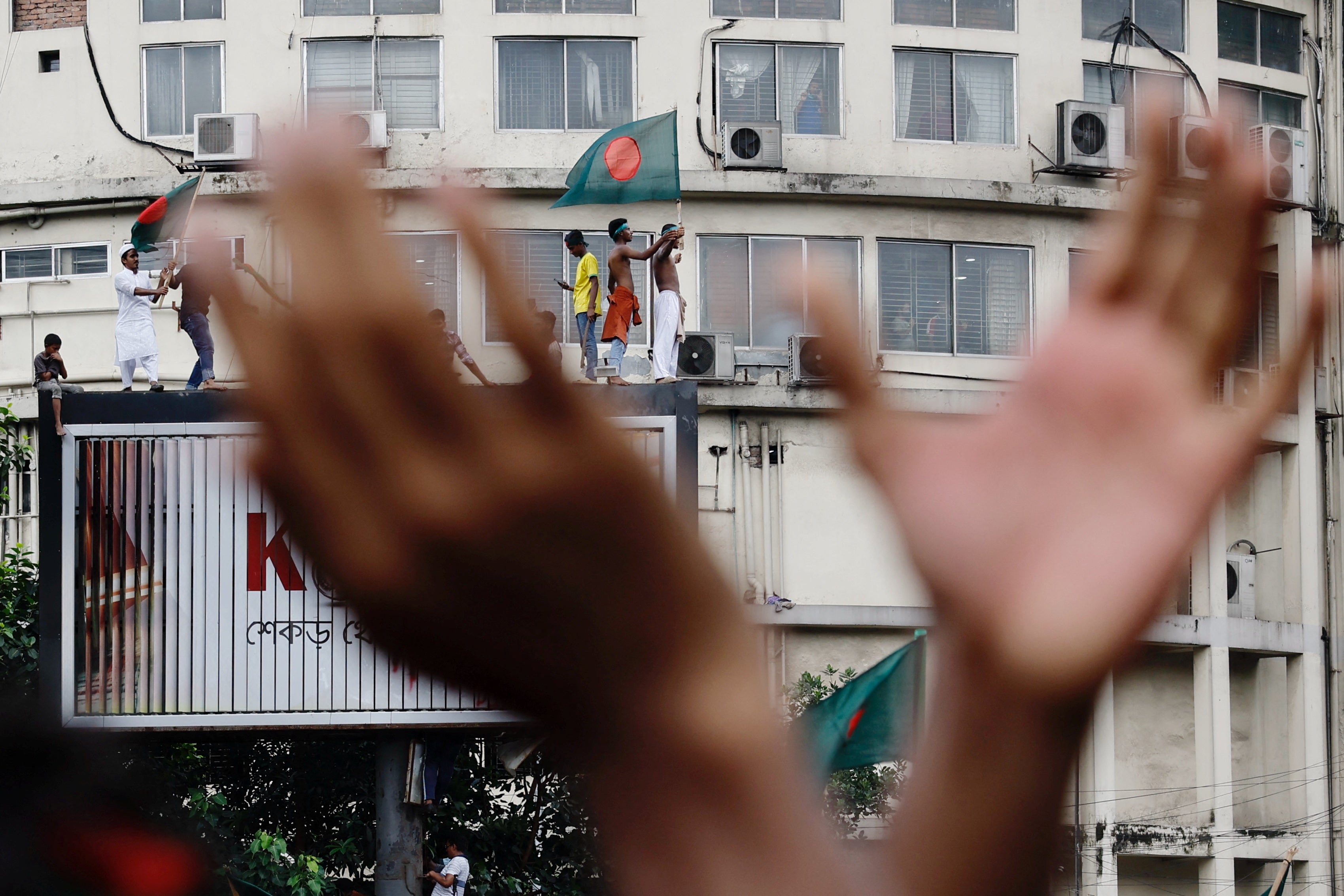 People celebrate the resignation of the prime minister in Dhaka, Bangladesh