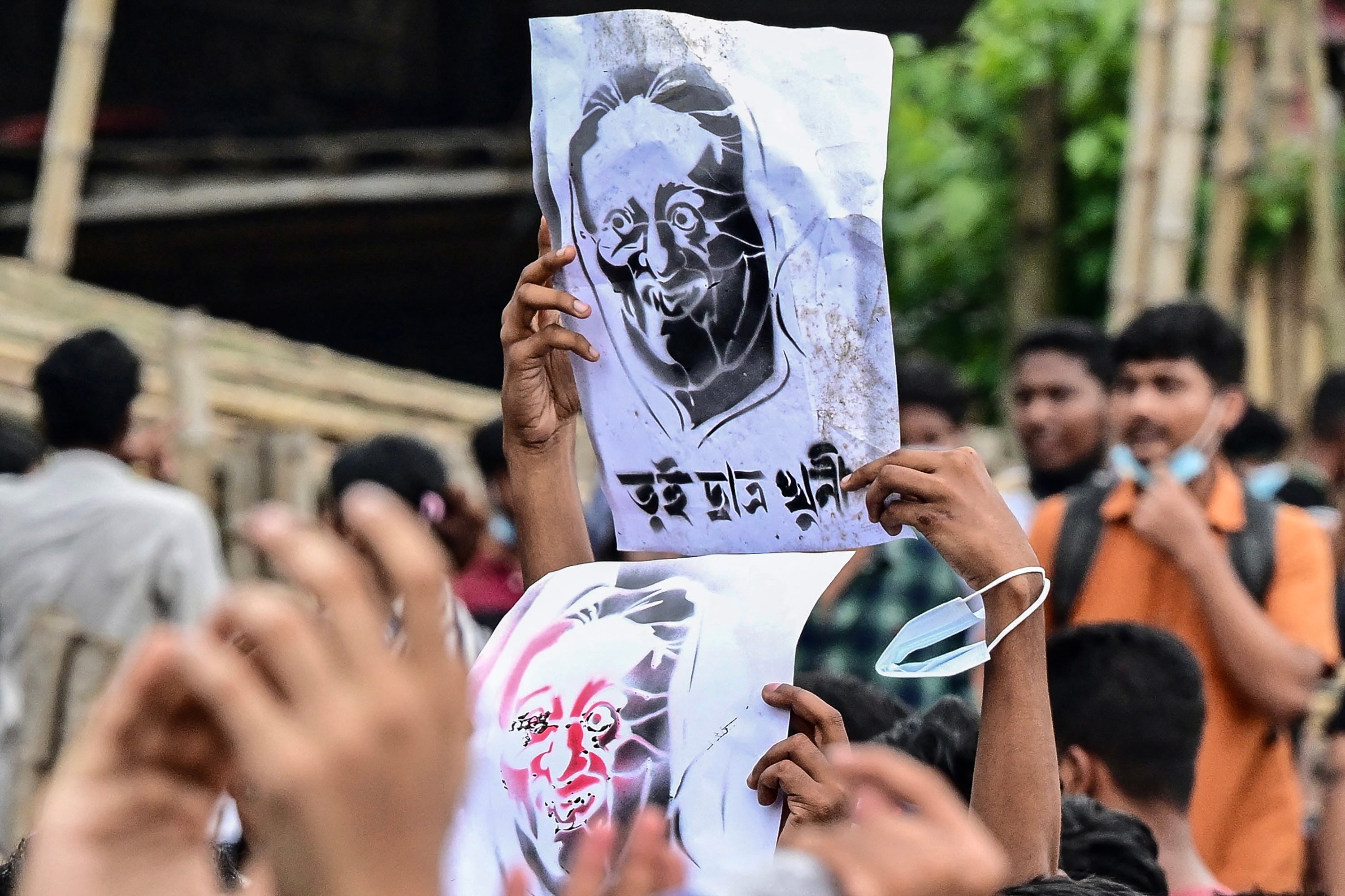 Students carry a portrait of Sheikh Hasina with the caption ‘You killed students’ during a protest march in Dhaka