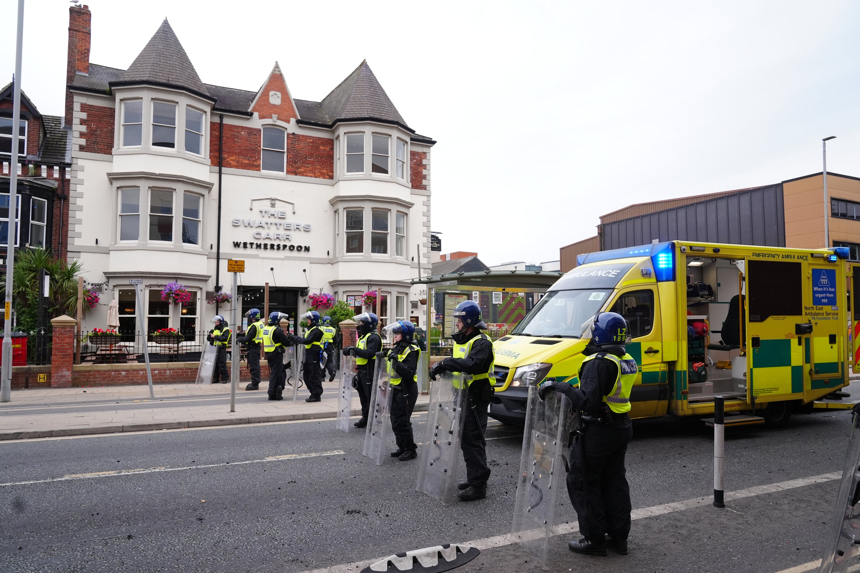 Police outside The Swatters Carr following a disturbance at the pub during an anti-immigration protest in Middlesbrough (Owen Humphreys/PA)