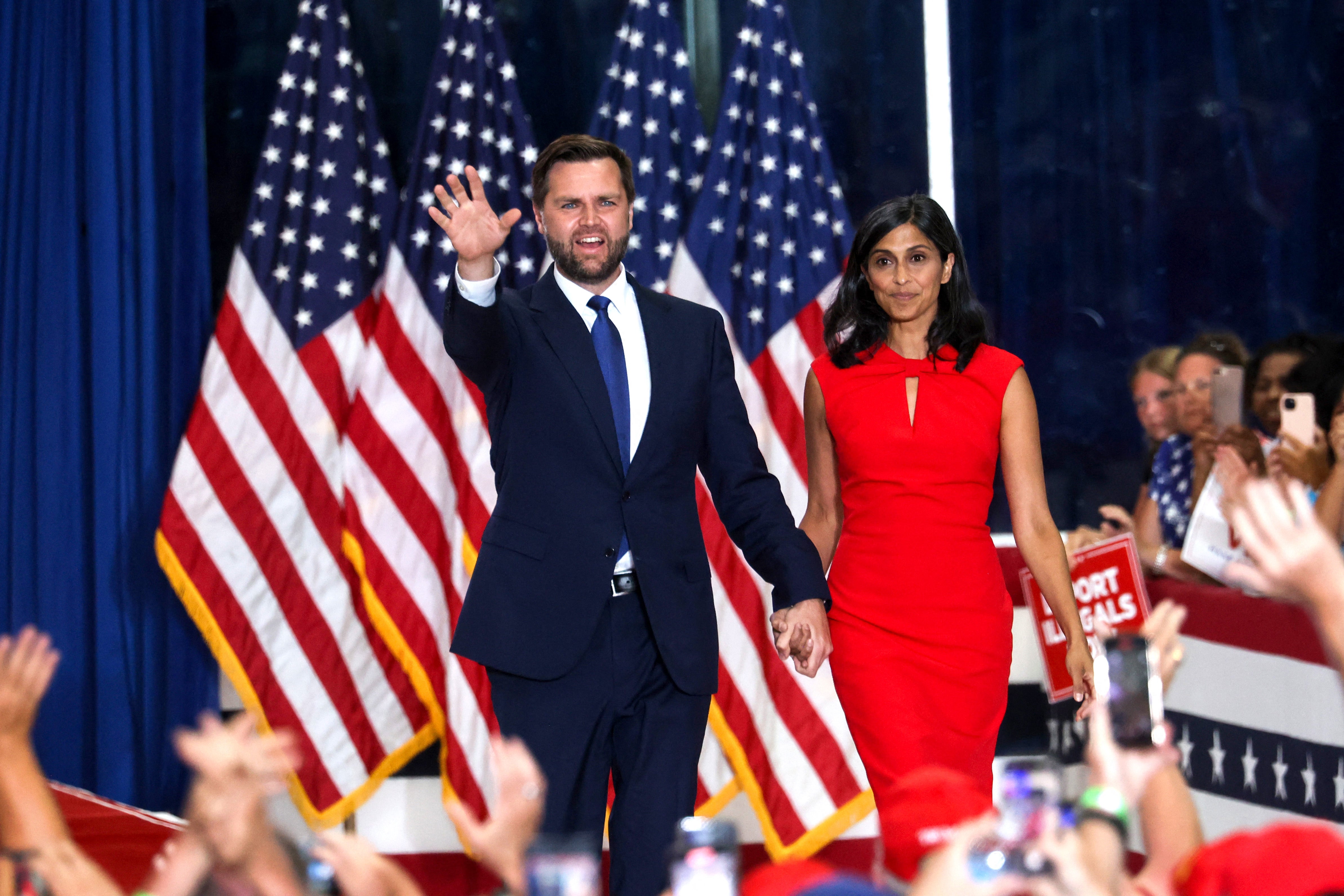 US Senator from Ohio and 2024 Republican vice presidential candidate J.D. Vance (L) arrives with wife US lawyer Usha Vance during a campaign rally at Herb Brooks National Hockey Center in Saint Cloud, Minnesota, on July 27, 2024